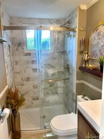 Walk-in shower with clear glass enclosure, a built-in niche, and a window Walk-in shower with clear glass enclosure, a built-in niche, and a window