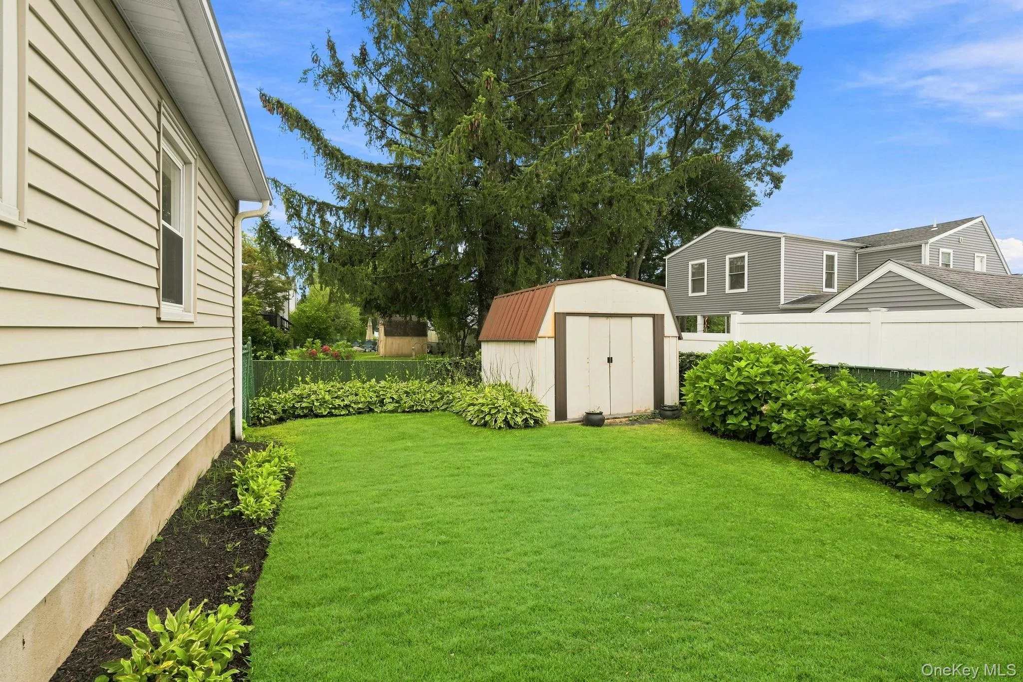 Private, fenced-in yard offering a peaceful outdoor escape Private, fenced-in yard offering a peaceful outdoor escape