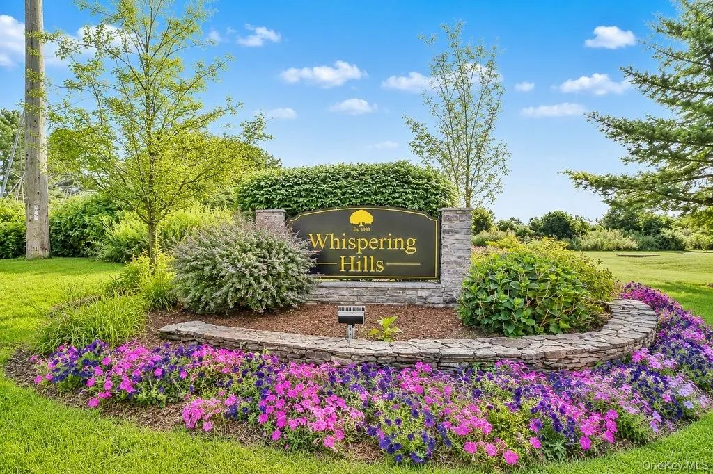 Entryway signage featuring stone pillars and a dark plaque with gold lettering Entryway signage featuring stone pillars and a dark plaque with gold lettering