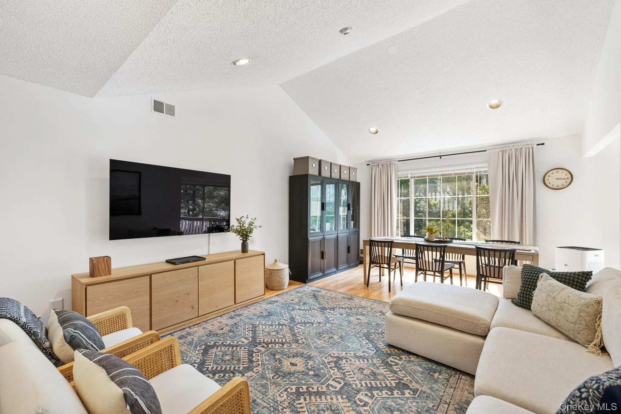 Living and dining room, with vaulted ceilings and large window lightening up the home. Living and dining room, with vaulted ceilings and large window lightening up the home.