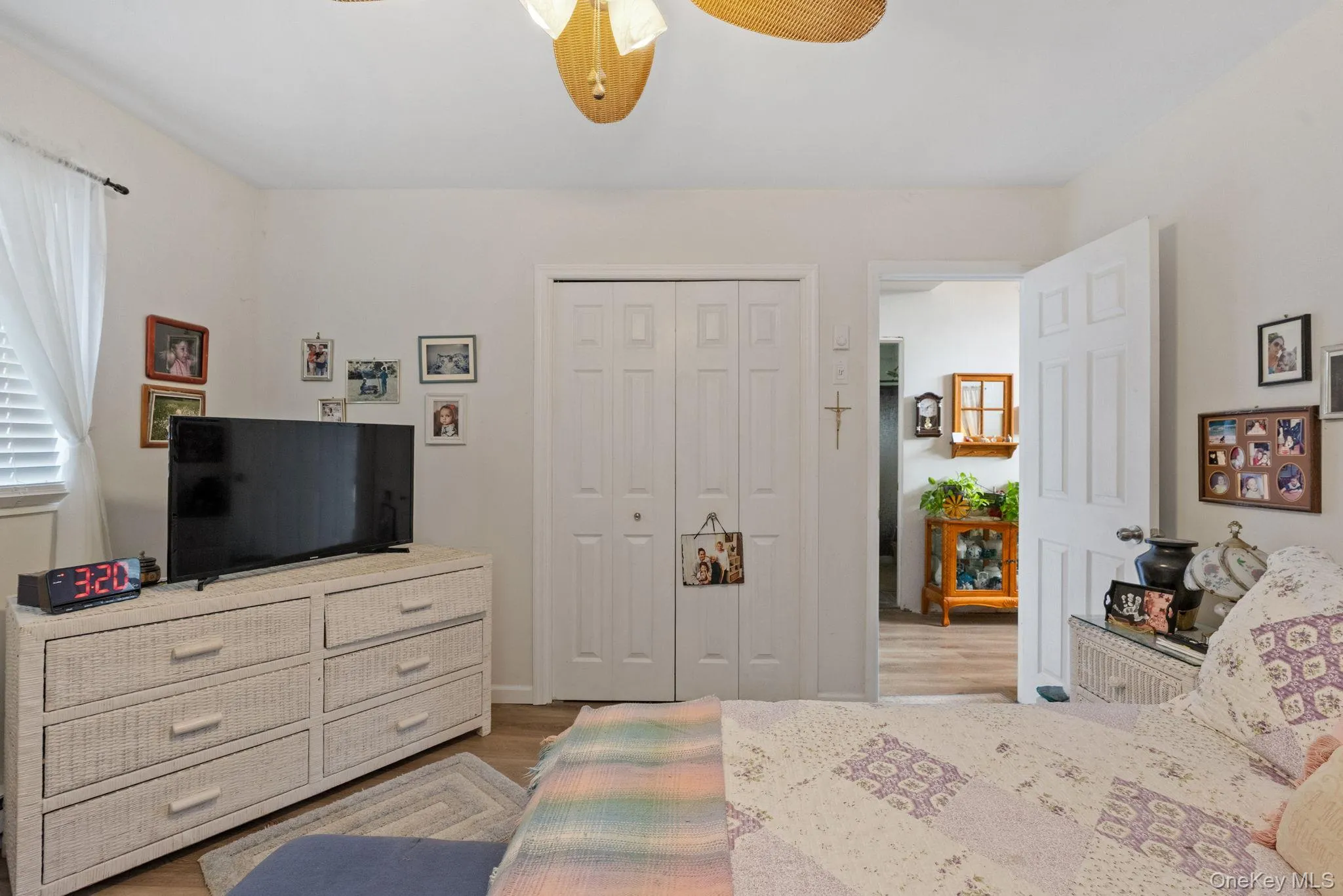 Bedroom with light wood finished floors, a closet, and a ceiling fan Bedroom with light wood finished floors, a closet, and a ceiling fan