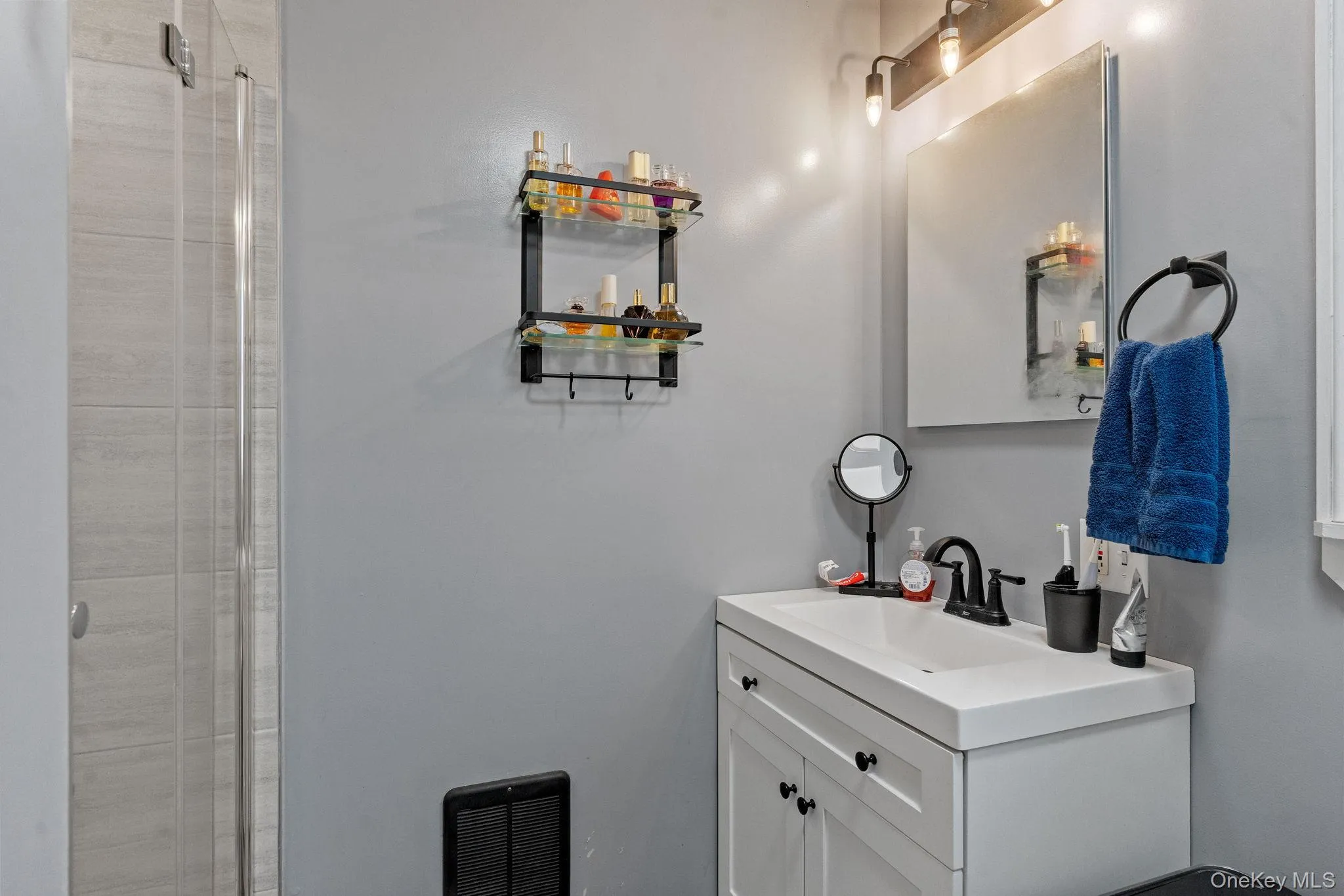 Bathroom featuring vanity and a shower stall Bathroom featuring vanity and a shower stall