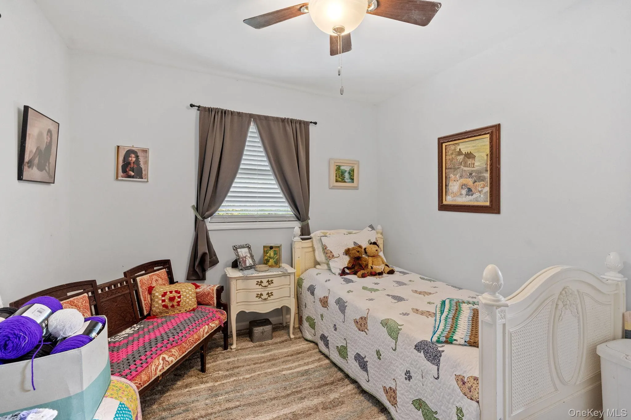 Carpeted bedroom with a ceiling fan Carpeted bedroom with a ceiling fan