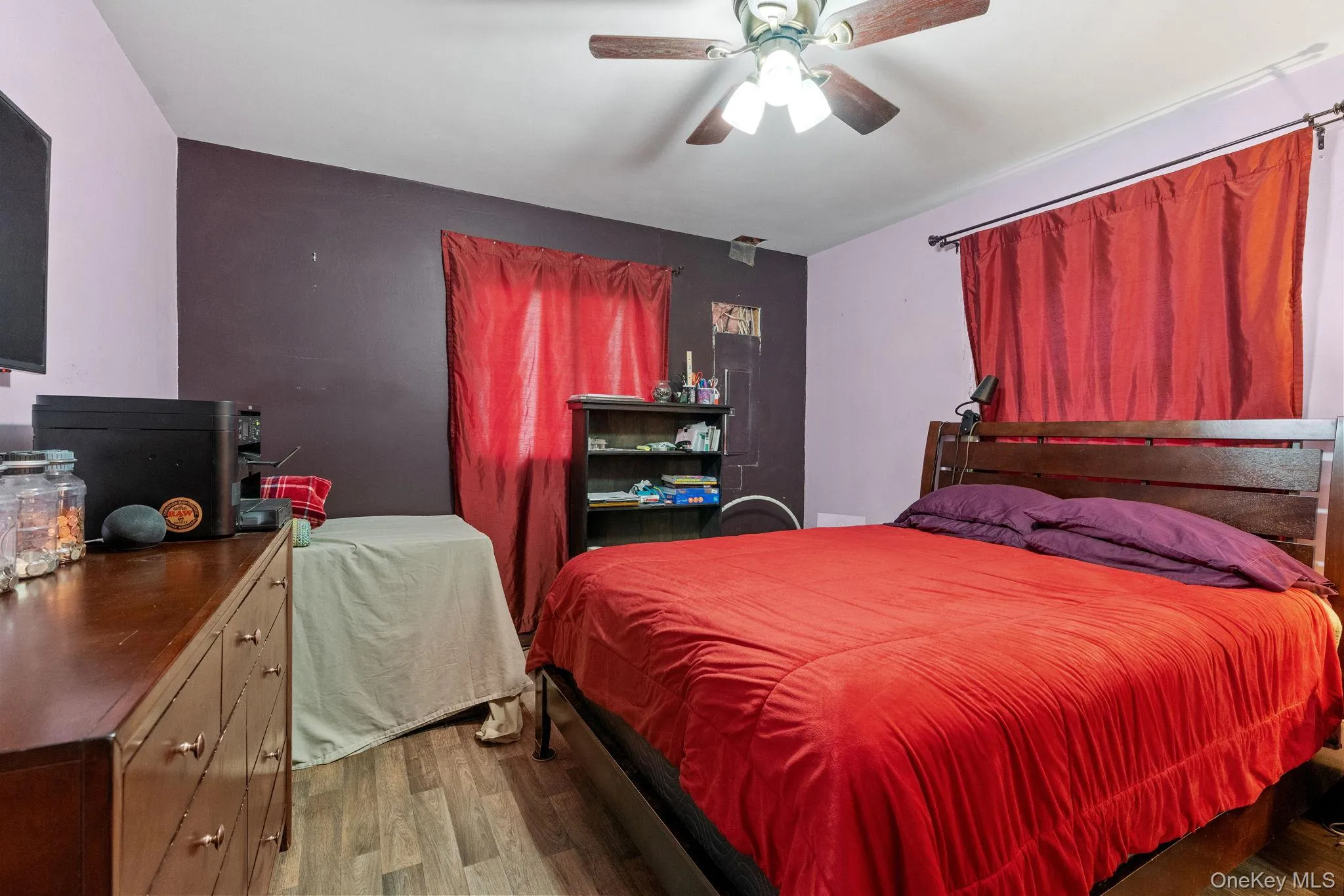 Bedroom with wood finished floors and a ceiling fan Bedroom with wood finished floors and a ceiling fan