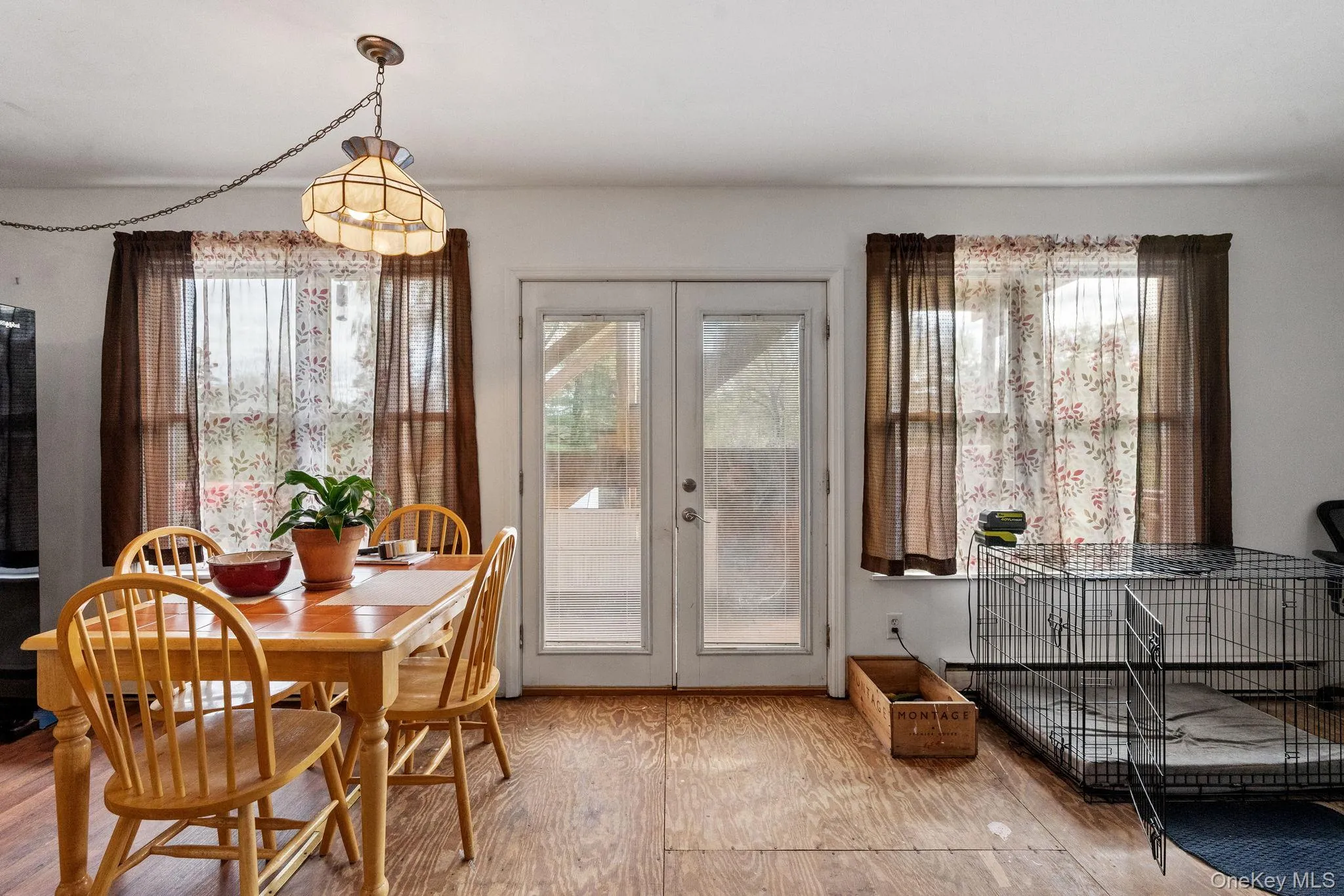 Dining room featuring french doors, plenty of natural light, and wood finished floors Dining room featuring french doors, plenty of natural light, and wood finished floors