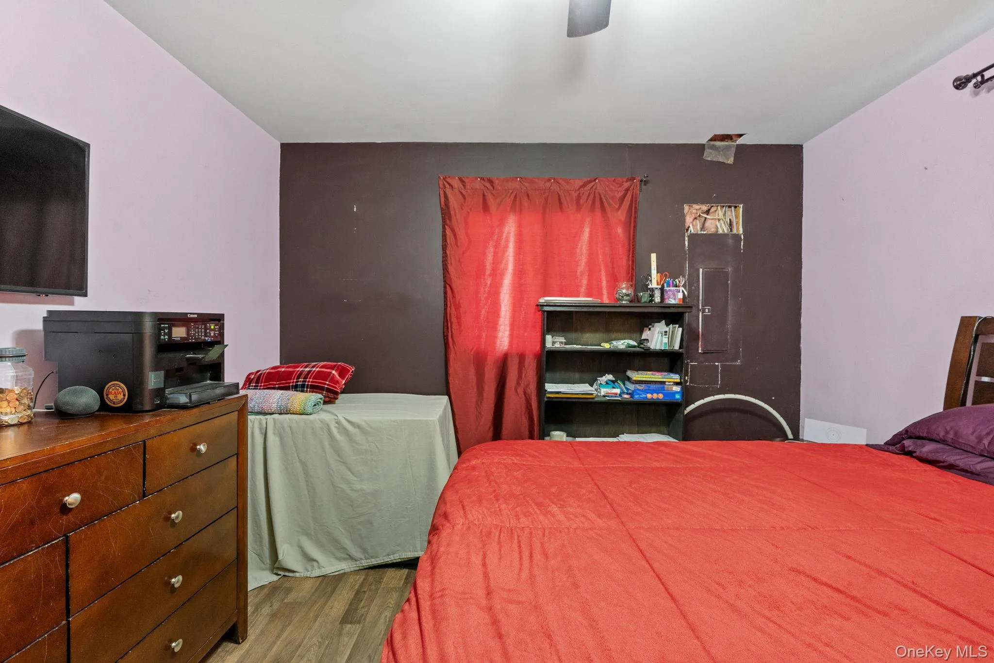Bedroom featuring wood finished floors and a ceiling fan Bedroom featuring wood finished floors and a ceiling fan