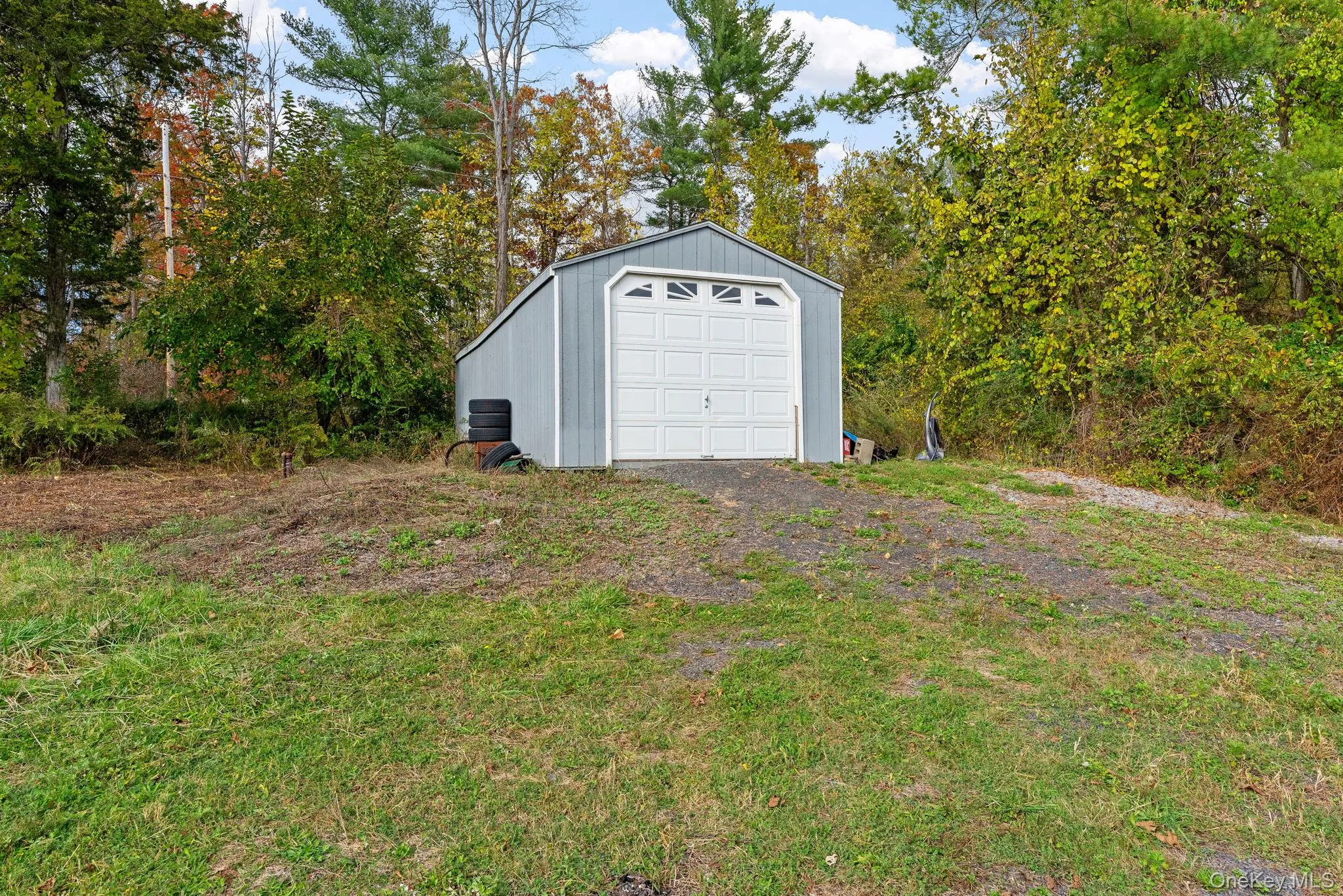 Garage featuring view of scattered trees Garage featuring view of scattered trees