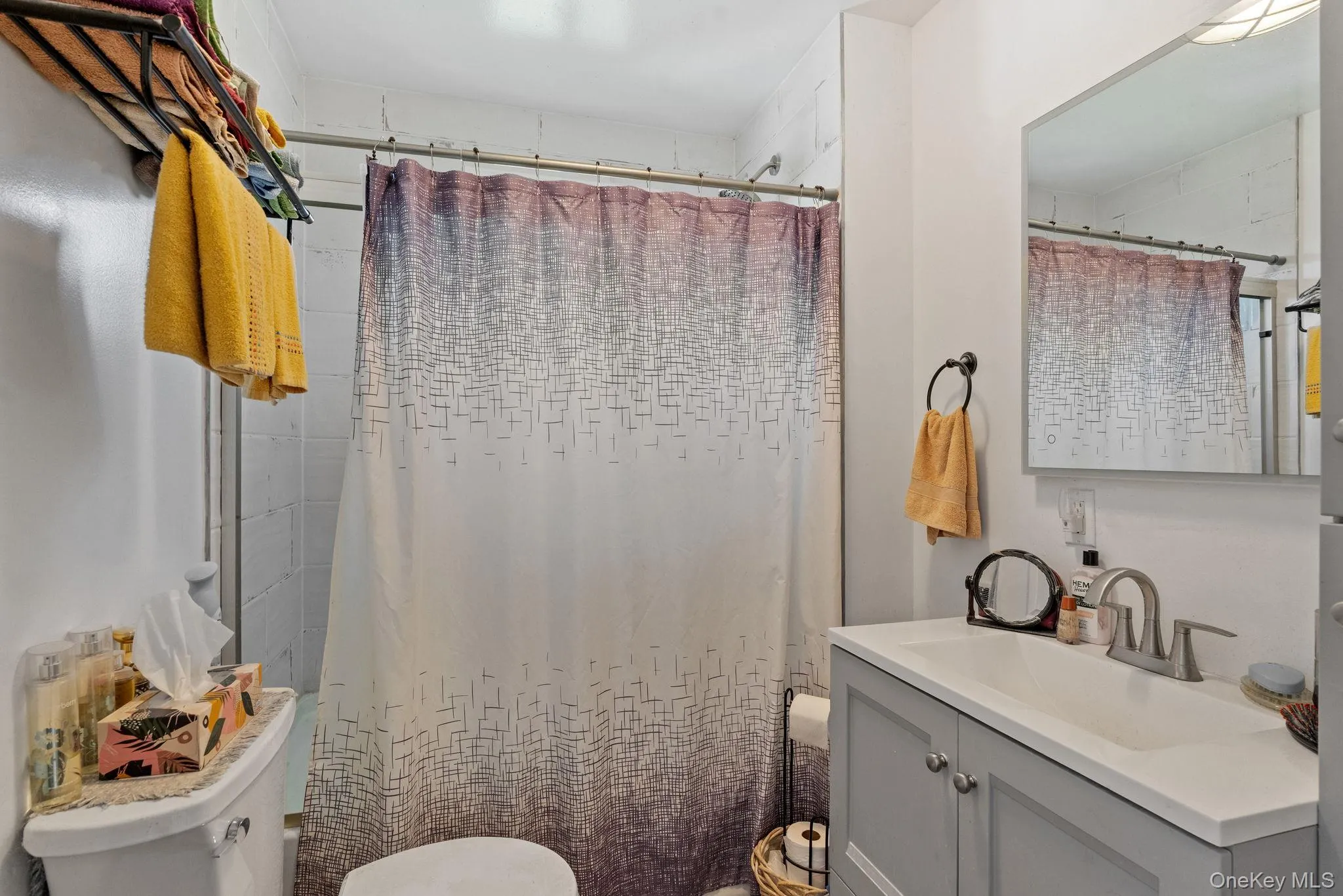 Bathroom with vanity and curtained shower Bathroom with vanity and curtained shower