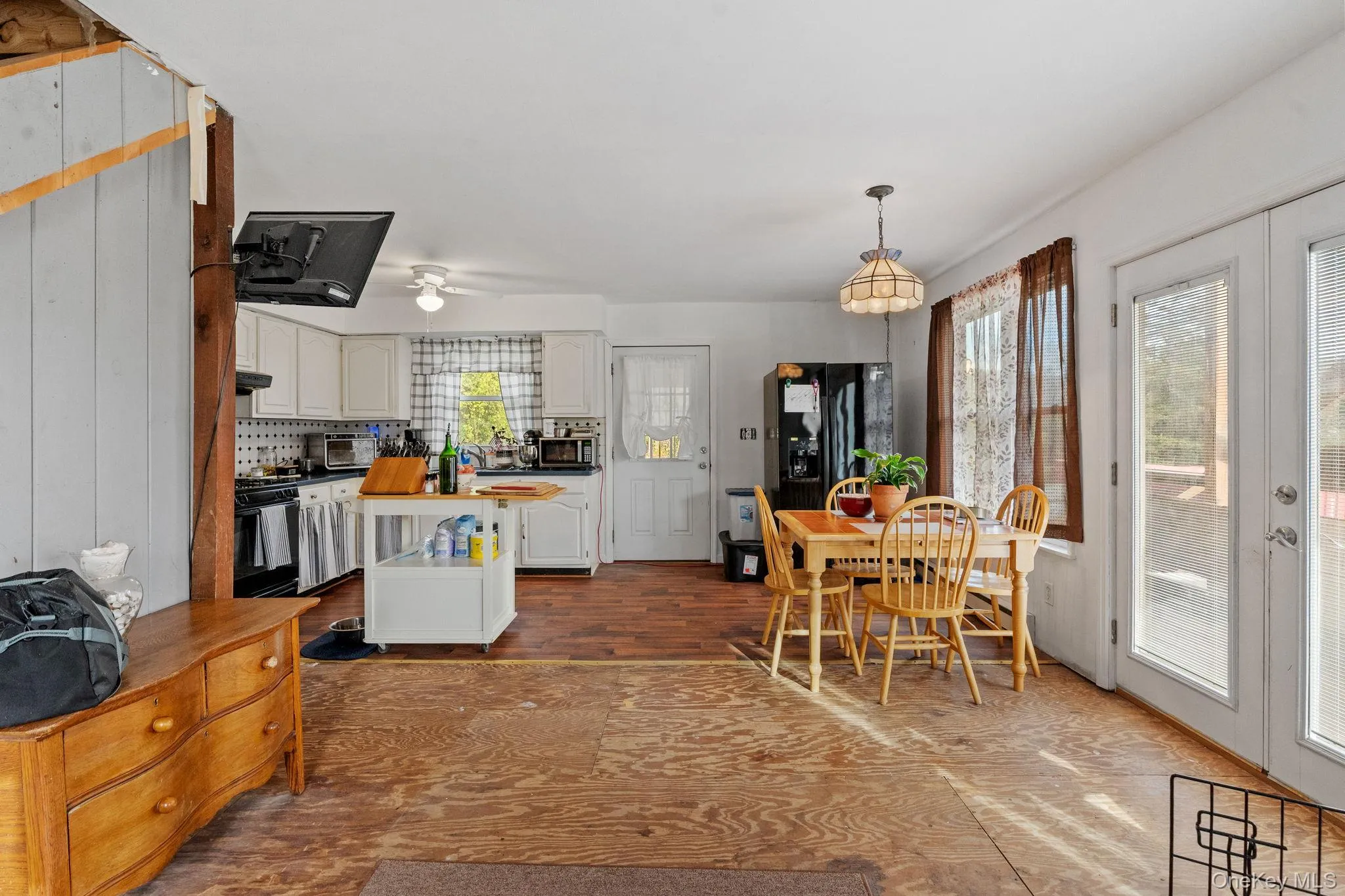 Dining area with dark wood-type flooring and french doors Dining area with dark wood-type flooring and french doors
