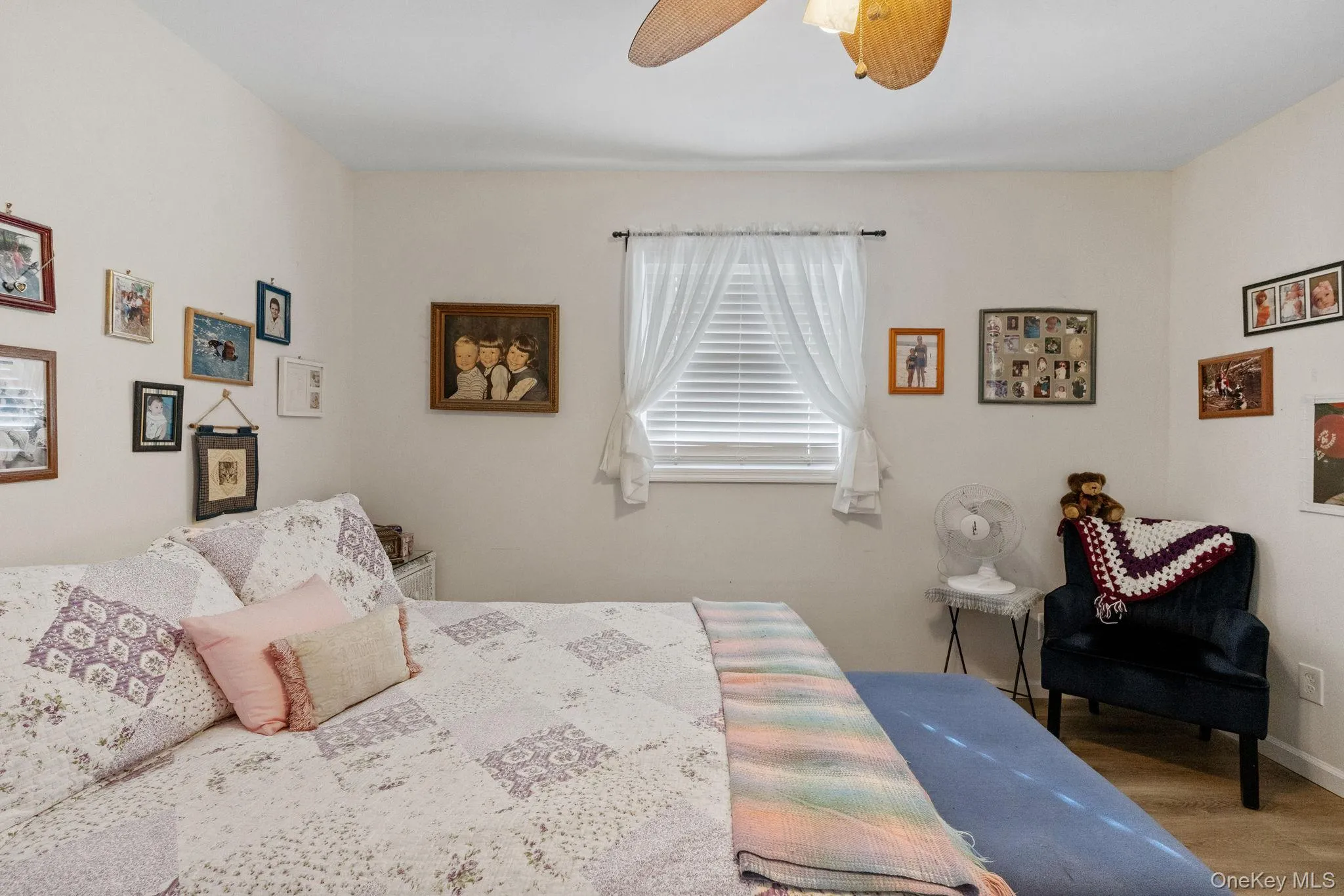 Bedroom with wood finished floors and ceiling fan Bedroom with wood finished floors and ceiling fan