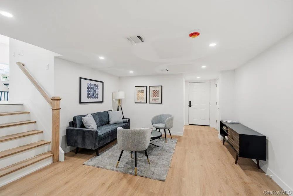 Step Down from the Main Level to a Cozy Den with Natural Oak wood floors complements the neutral wall tones Step Down from the Main Level to a Cozy Den with Natural Oak wood floors complements the neutral wall tones