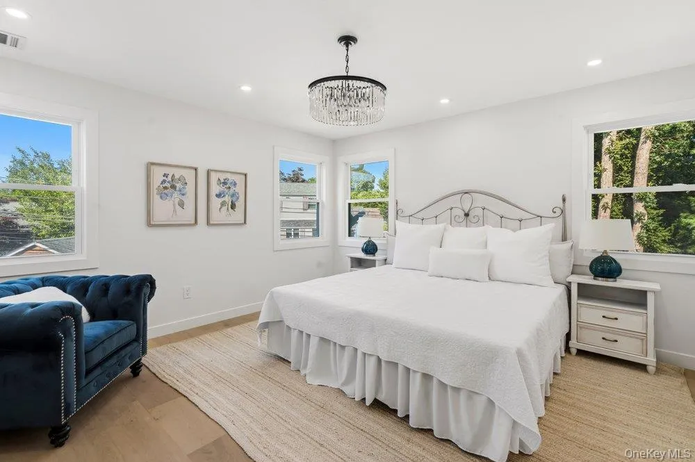 Bright Primary Bedroom features White Oak floor, and a crystal chandelier! Bright Primary Bedroom features White Oak floor, and a crystal chandelier!