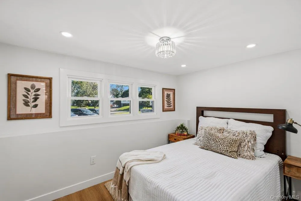4th Bedroom on the Den Level With White Oak Floors, recessed lighting, and a crystal chandelier 4th Bedroom on the Den Level With White Oak Floors, recessed lighting, and a crystal chandelier