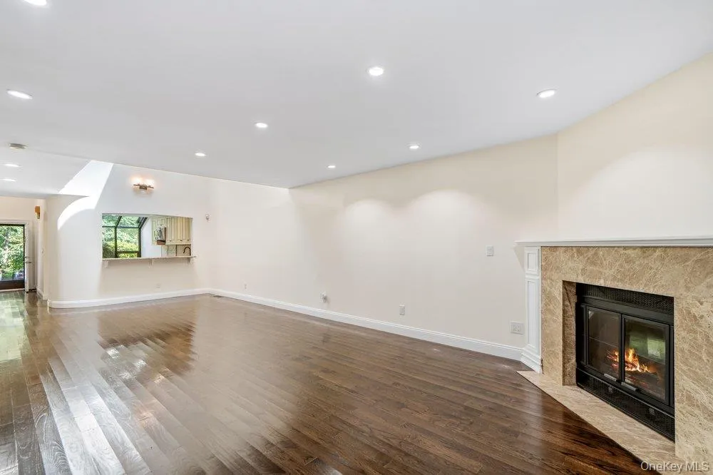 with wood burning fireplace and entry to deck with wood burning fireplace and entry to deck