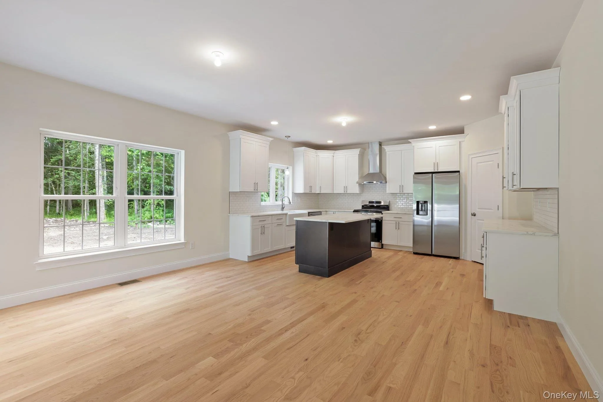 Large dining room with hardwood floors and recessed lighting. Large dining room with hardwood floors and recessed lighting.
