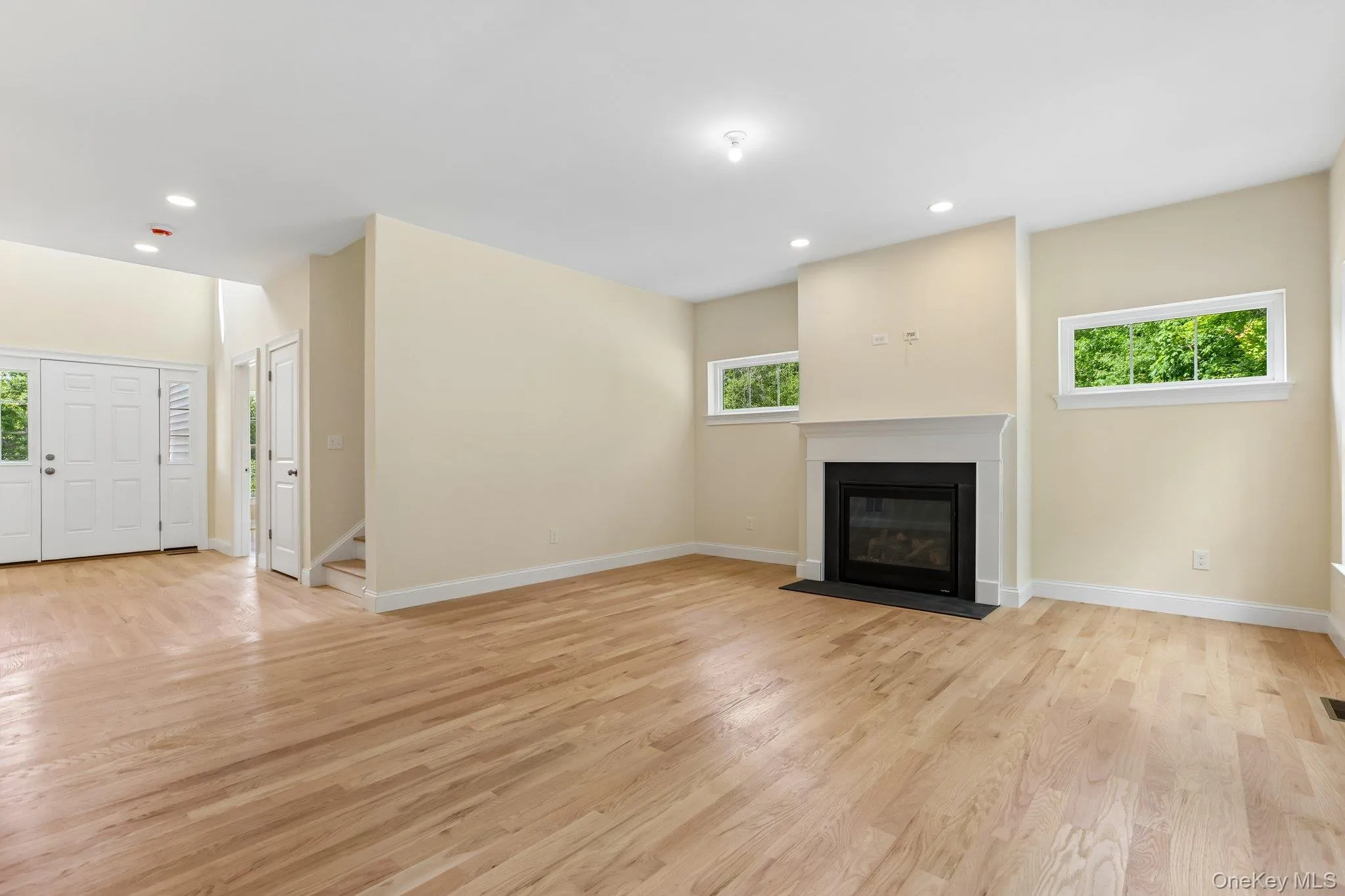 Large living room with fireplace and hardwood floors. Large living room with fireplace and hardwood floors.