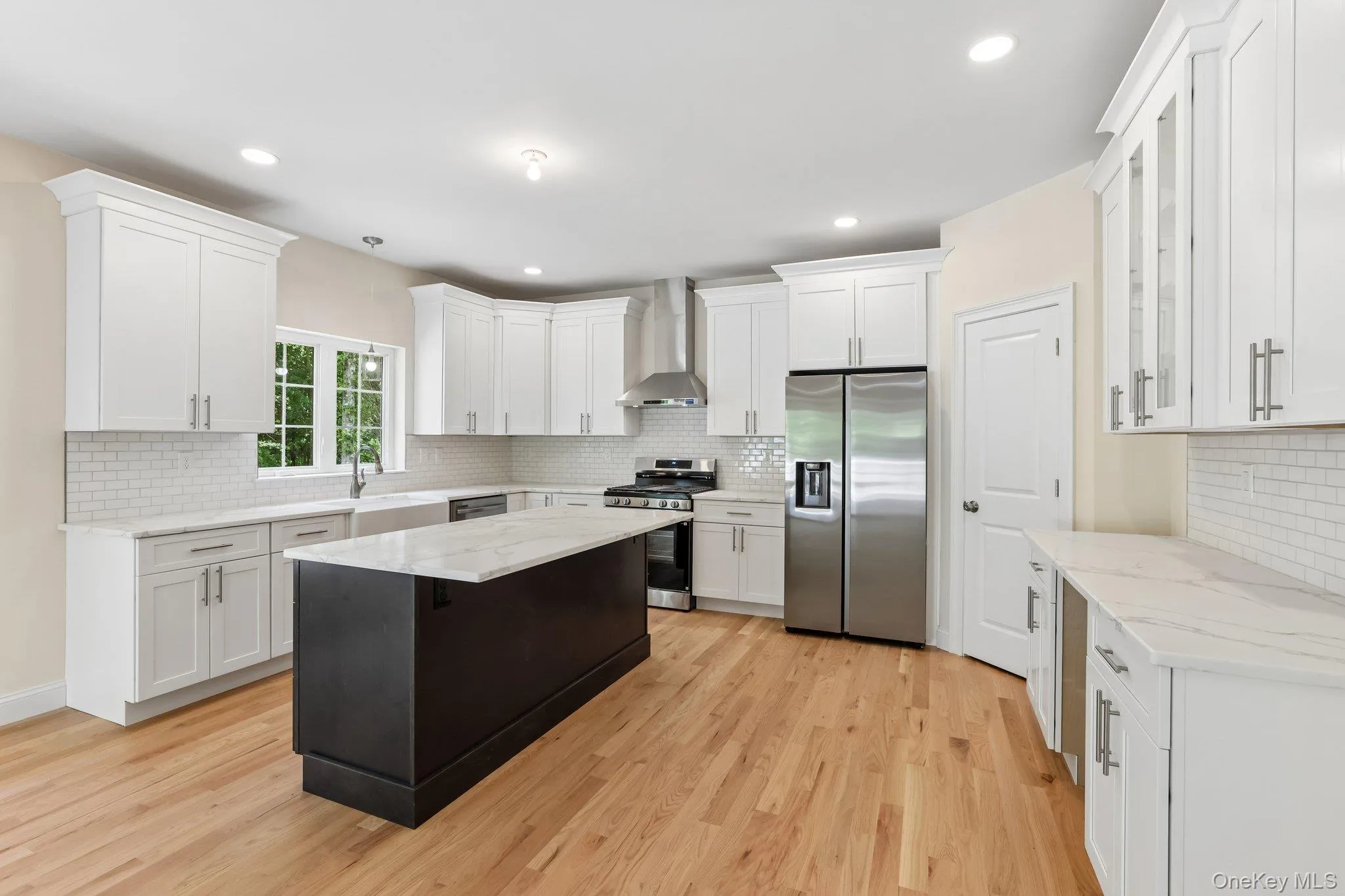 Kitchen with stainless steel appliances and large island. Kitchen with stainless steel appliances and large island.