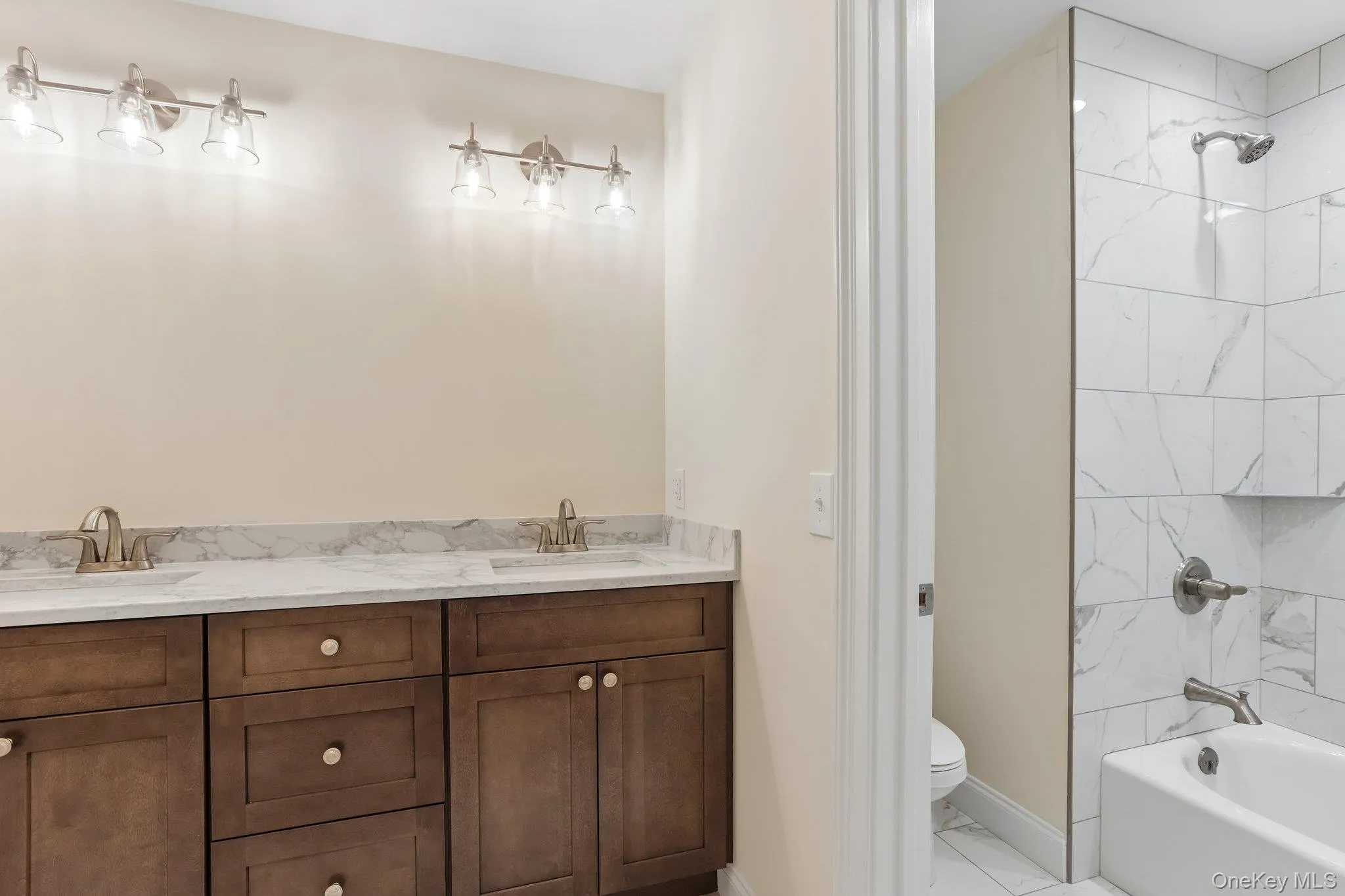 Hall bathroom with quartz counter tops and dual sinks. Hall bathroom with quartz counter tops and dual sinks.