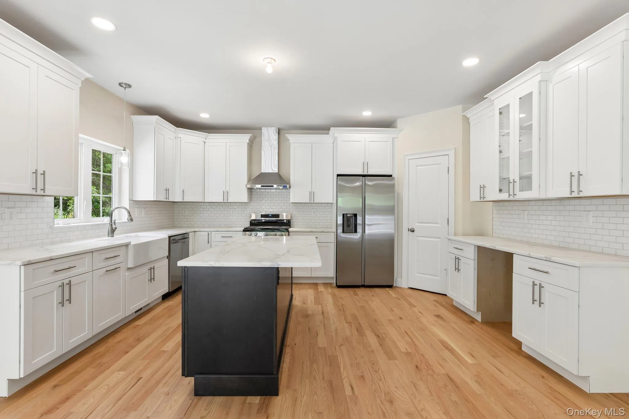Kitchen with stainless steel appliances and large island. Kitchen with stainless steel appliances and large island.