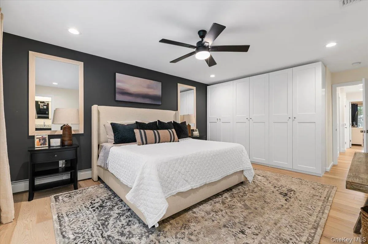 Recessed lighting, light wood-finish flooring, ceiling fan, white built-in cabinetry, and neutral wall paint Recessed lighting, light wood-finish flooring, ceiling fan, white built-in cabinetry, and neutral wall paint