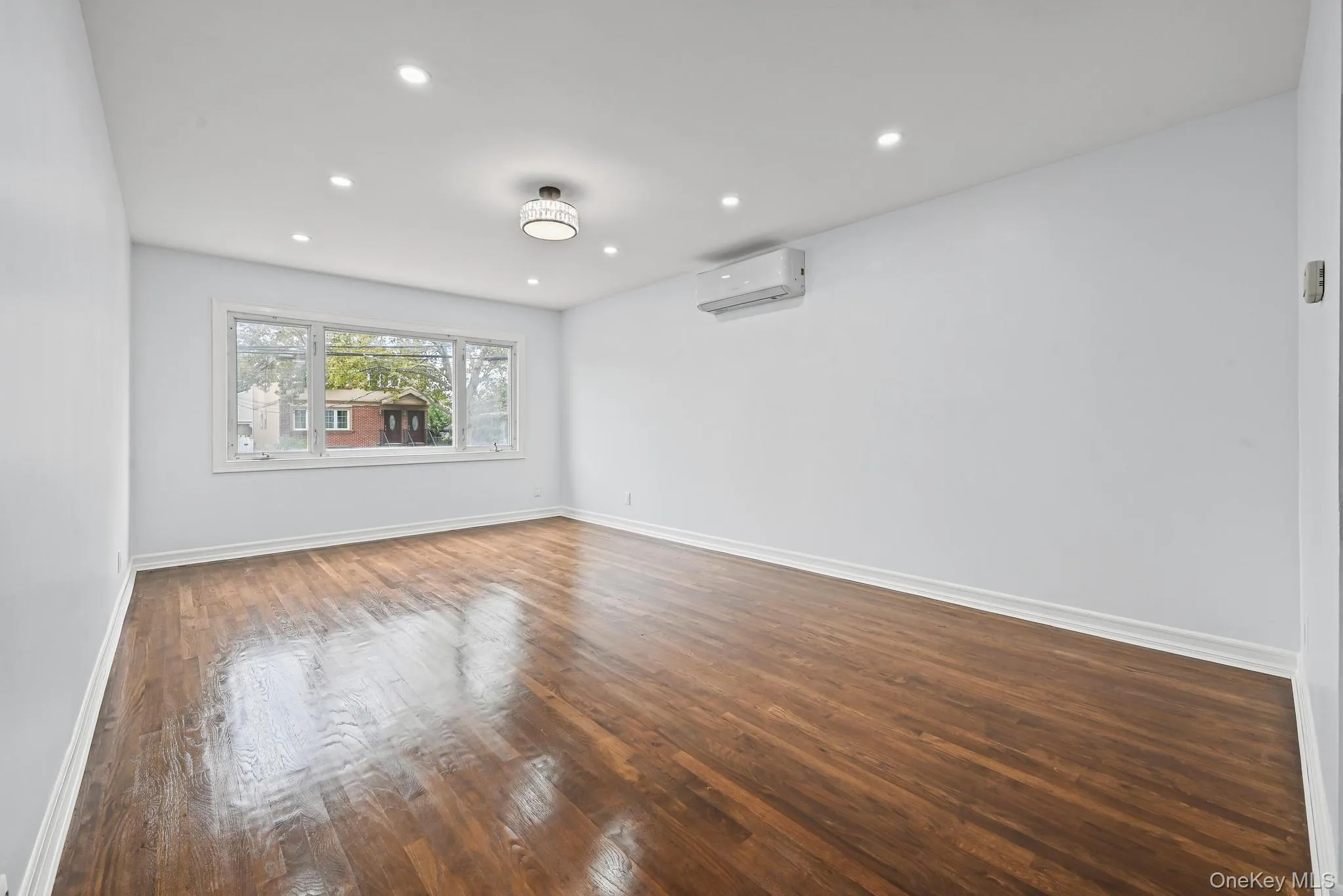 Unfurnished room with dark wood-style flooring and recessed lighting Unfurnished room with dark wood-style flooring and recessed lighting