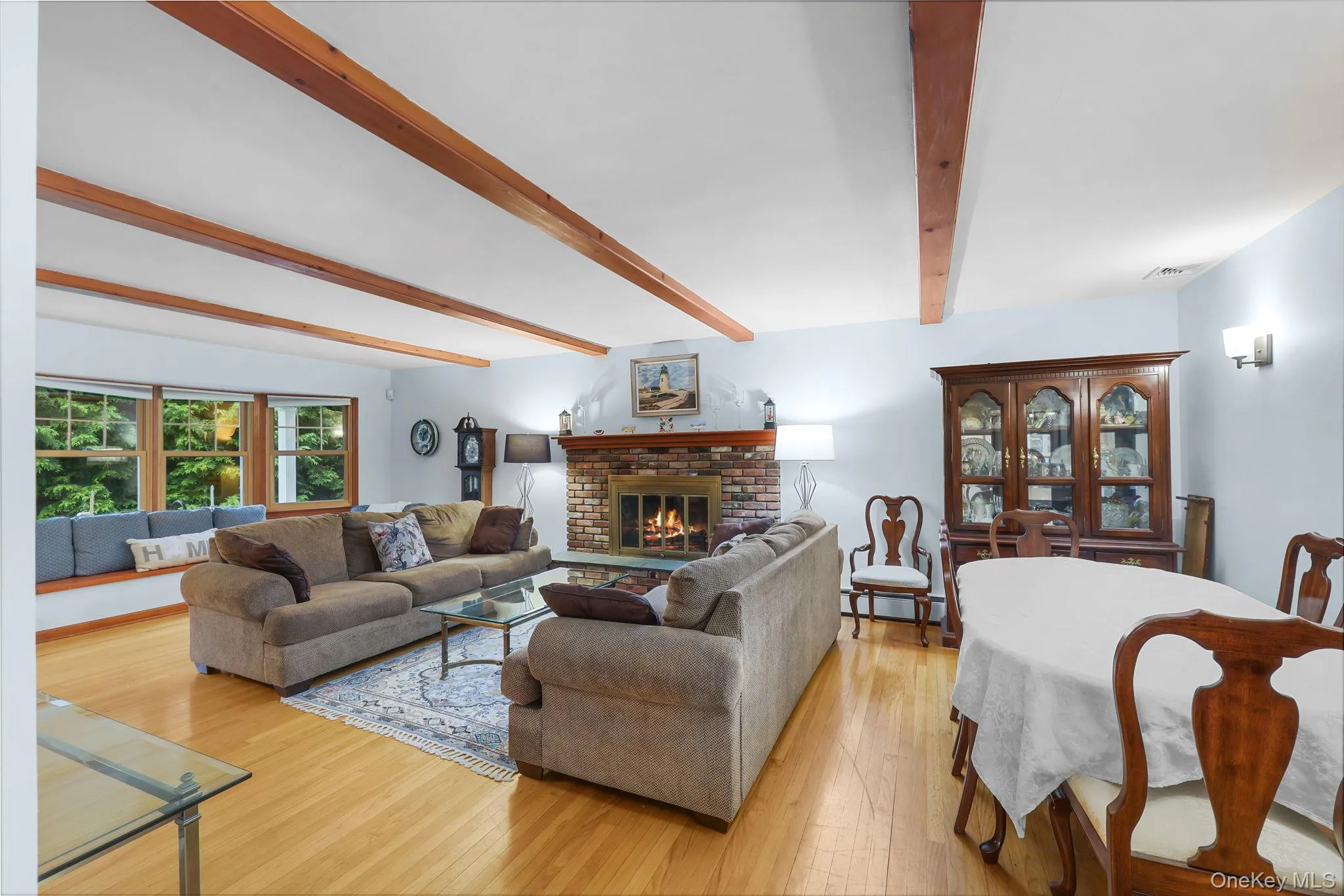 Spacious Formal Living Room with Center Wood Burning Fireplace with Mantle and Hearth Spacious Formal Living Room with Center Wood Burning Fireplace with Mantle and Hearth