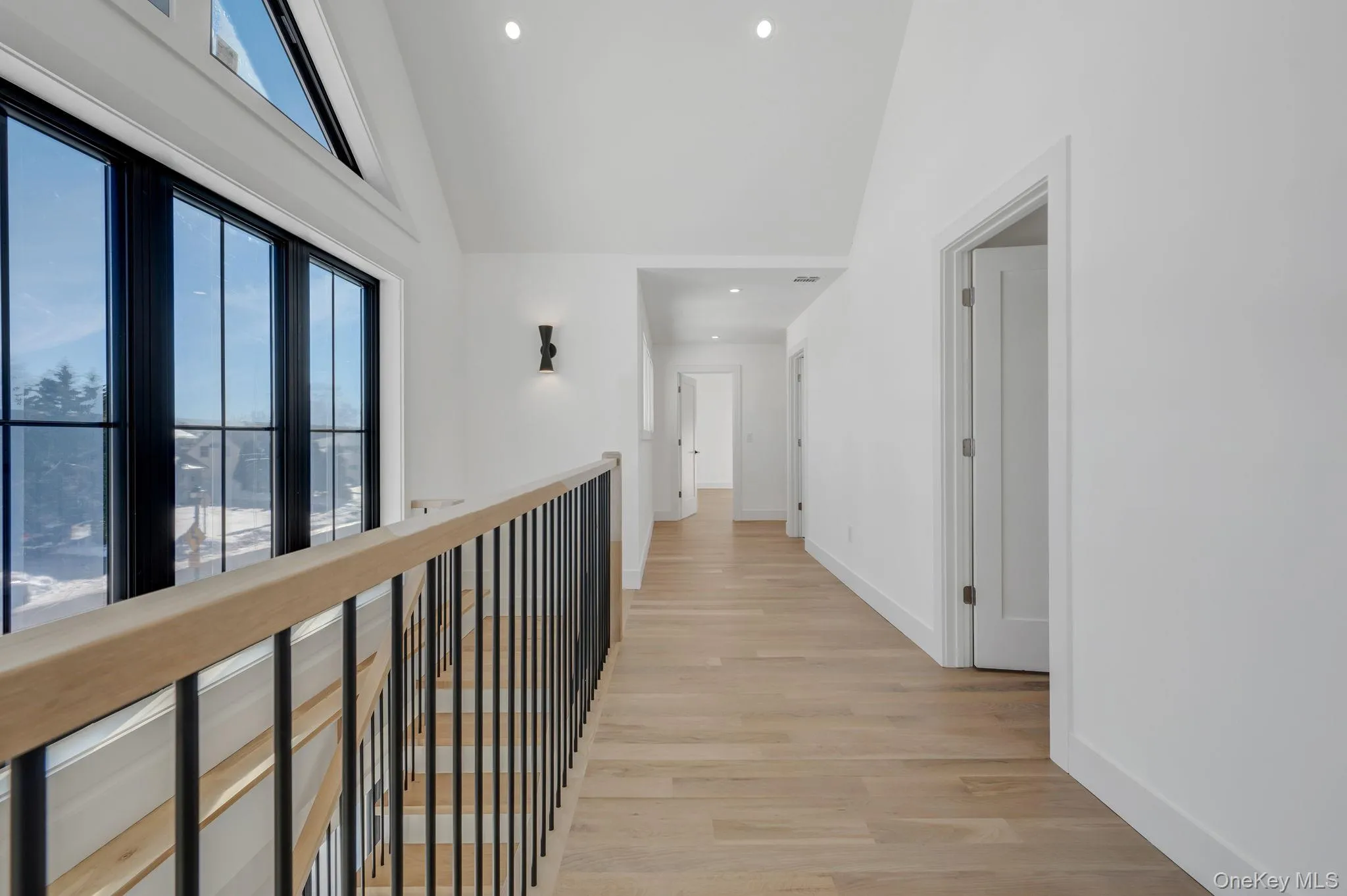 Beautiful second floor landing with large windows providing natural light. Beautiful second floor landing with large windows providing natural light.