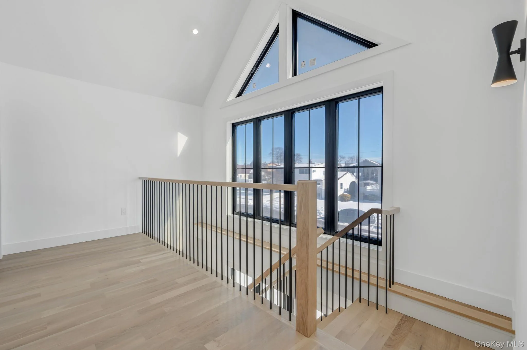 Beautiful second floor landing with large windows providing natural light. Beautiful second floor landing with large windows providing natural light.