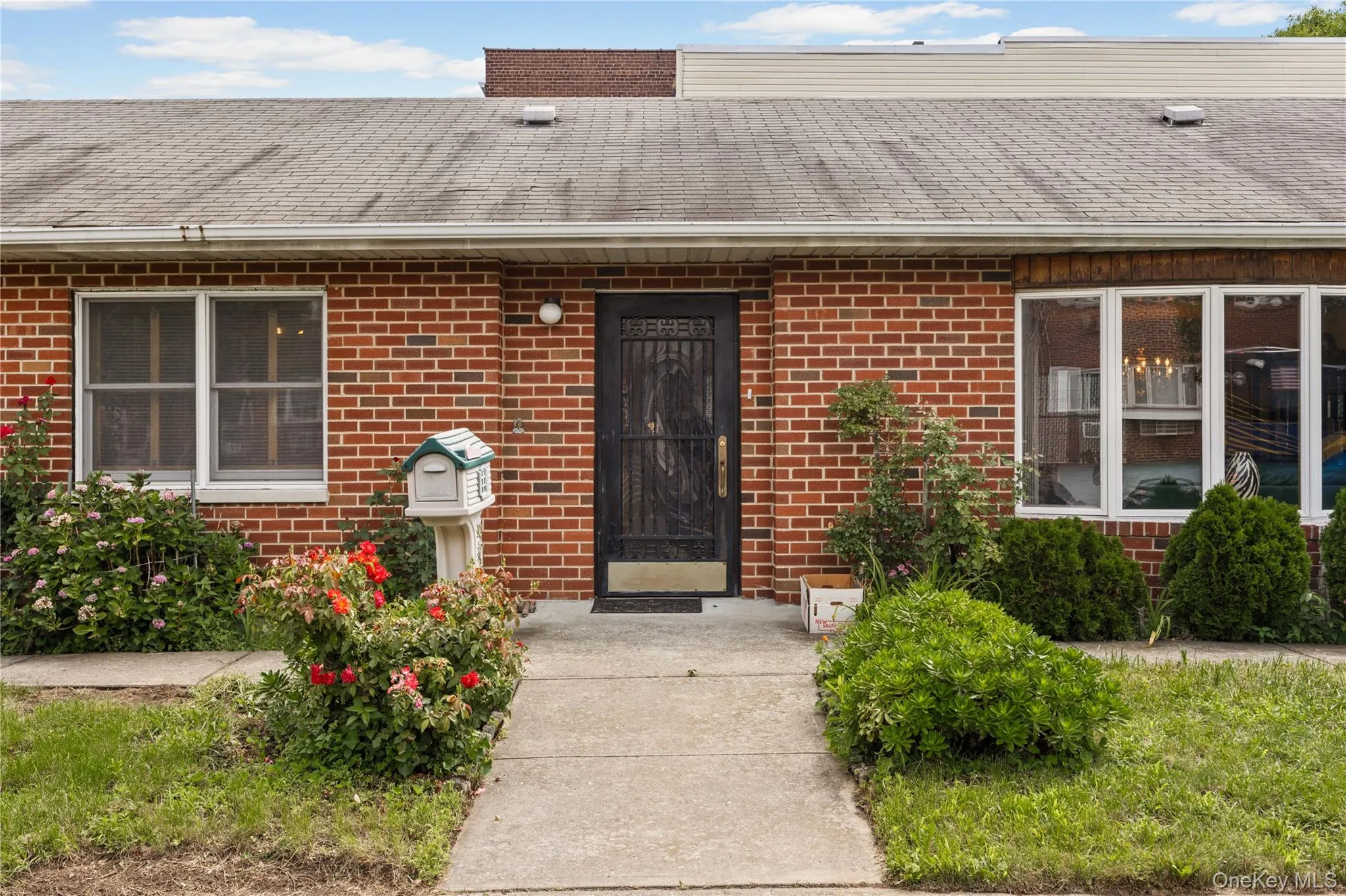 Brick facade home featuring a walkway leading to the entry Brick facade home featuring a walkway leading to the entry