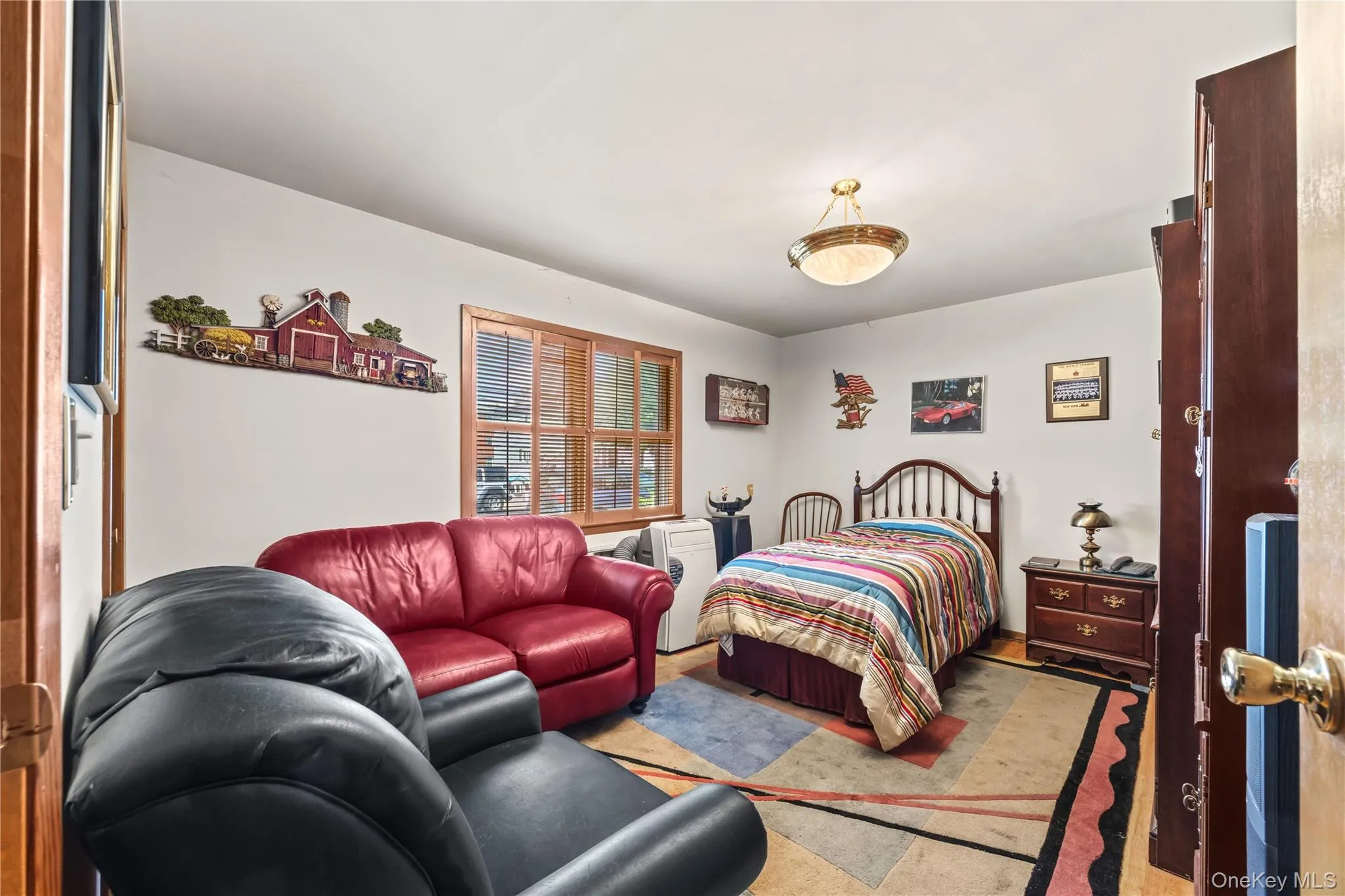 Interior room featuring hardwood flooring and a ceiling-mounted light fixture Interior room featuring hardwood flooring and a ceiling-mounted light fixture