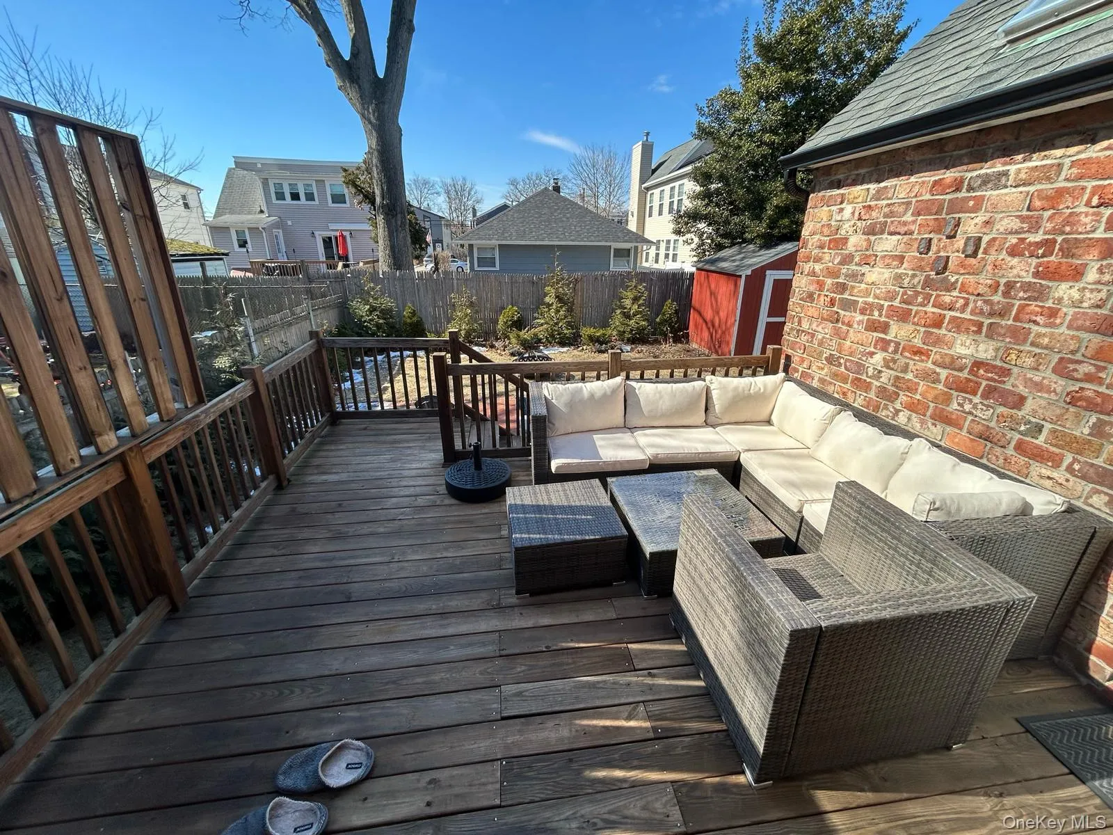 Wooden deck with a shed, a residential view, a fenced backyard, an outdoor structure, and an outdoor living space Wooden deck with a shed, a residential view, a fenced backyard, an outdoor structure, and an outdoor living space