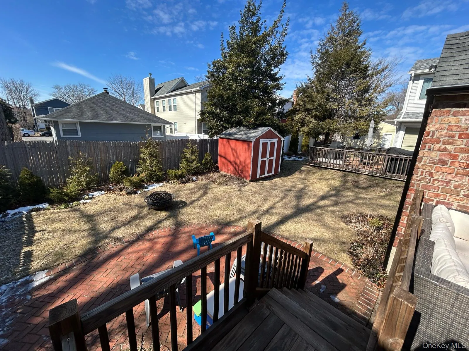 Deck featuring a shed, a fire pit, a fenced backyard, and an outbuilding Deck featuring a shed, a fire pit, a fenced backyard, and an outbuilding