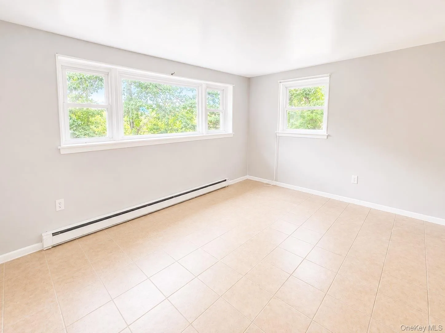 Large windows, light-toned walls, and tile flooring Large windows, light-toned walls, and tile flooring