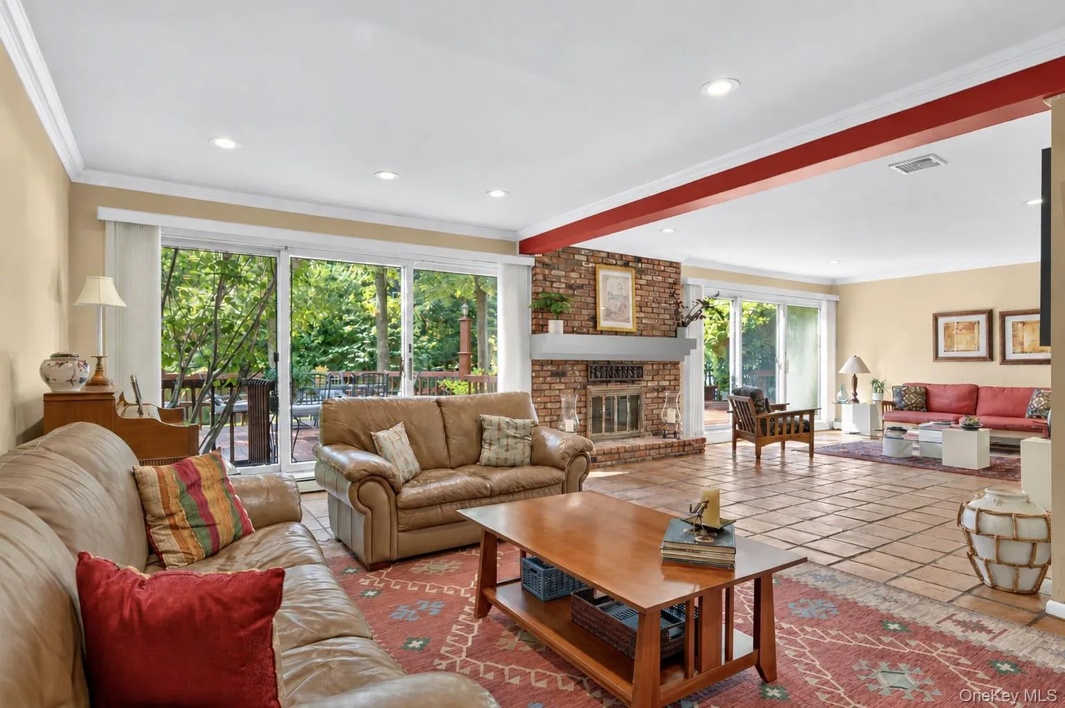 Den with sliders and shared fireplace Den with sliders and shared fireplace