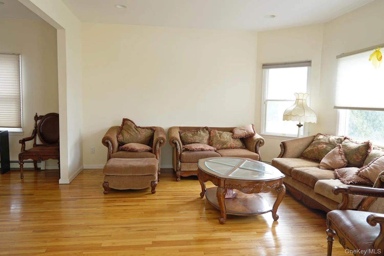 Living area with recessed lighting, light wood finished floors, and a baseboard radiator Living area with recessed lighting, light wood finished floors, and a baseboard radiator