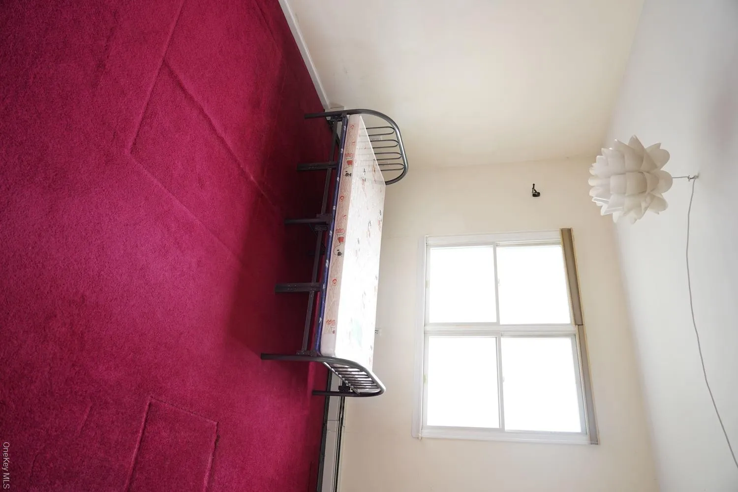 Unfurnished bedroom featuring a notable chandelier and carpet floors Unfurnished bedroom featuring a notable chandelier and carpet floors