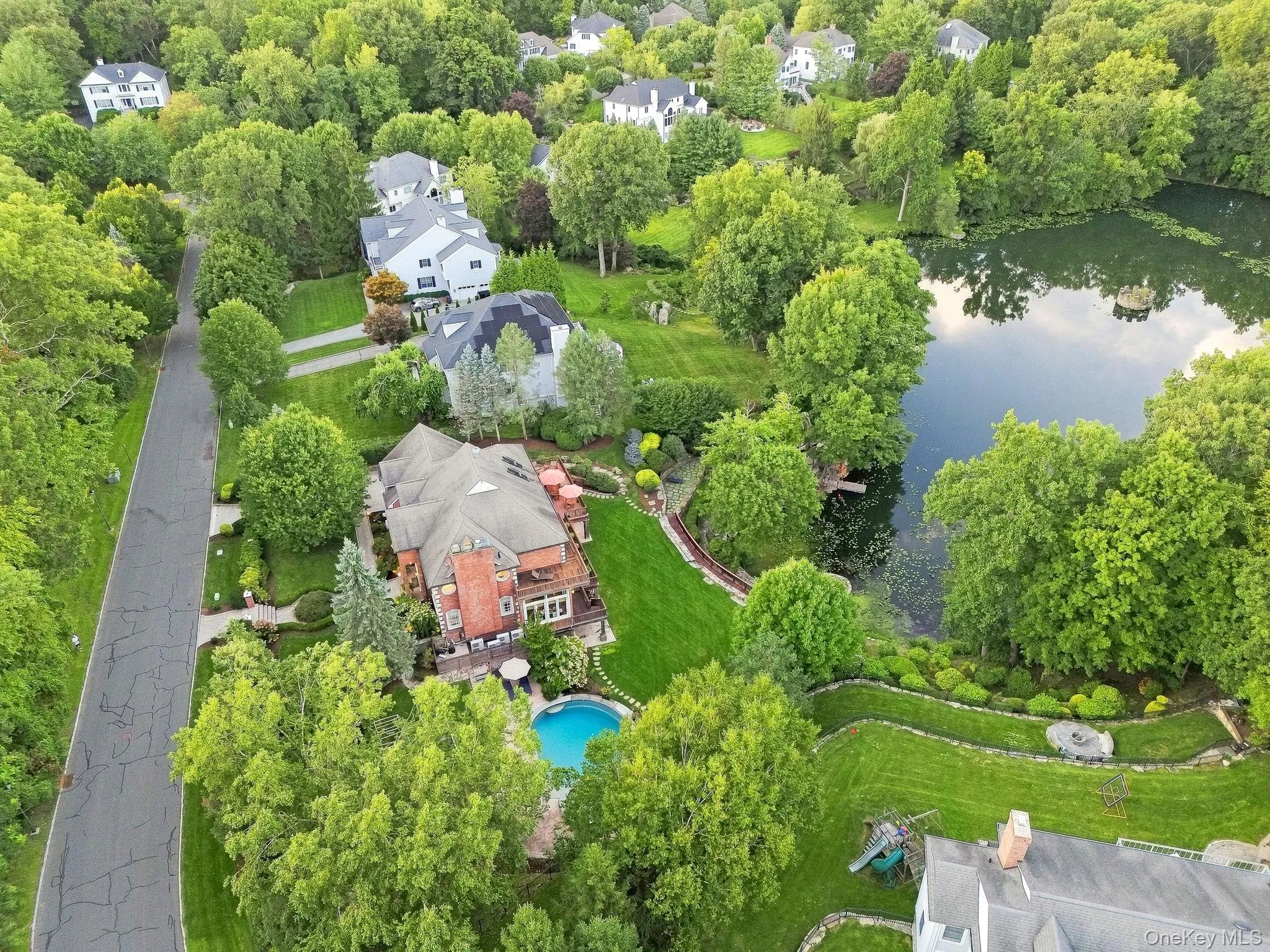 Overlooking the home, pool, lake, dock, patio, gazebo and waterfall Overlooking the home, pool, lake, dock, patio, gazebo and waterfall