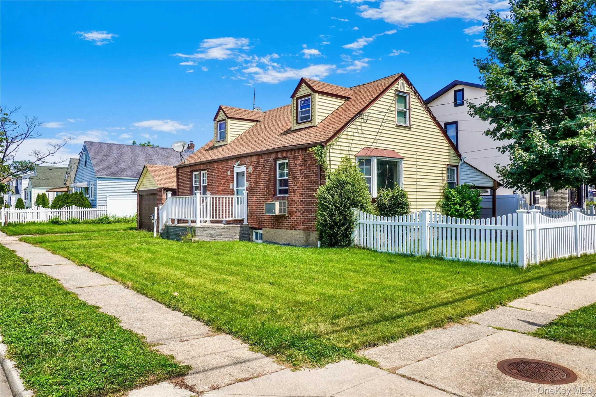 Traditional dormer-style home featuring brick and siding exterior Traditional dormer-style home featuring brick and siding exterior