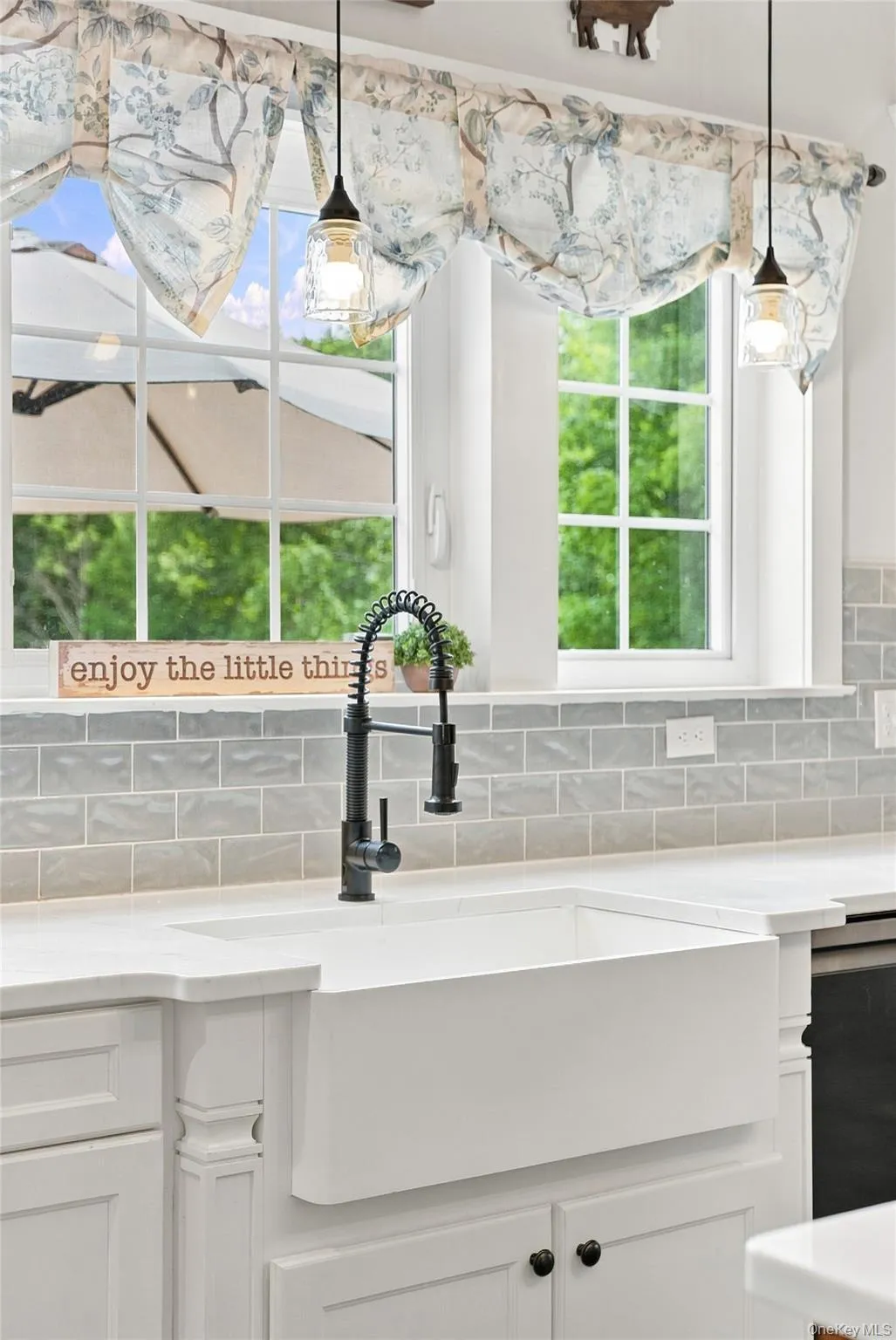 Deep farmhouse sink with backyard views Deep farmhouse sink with backyard views