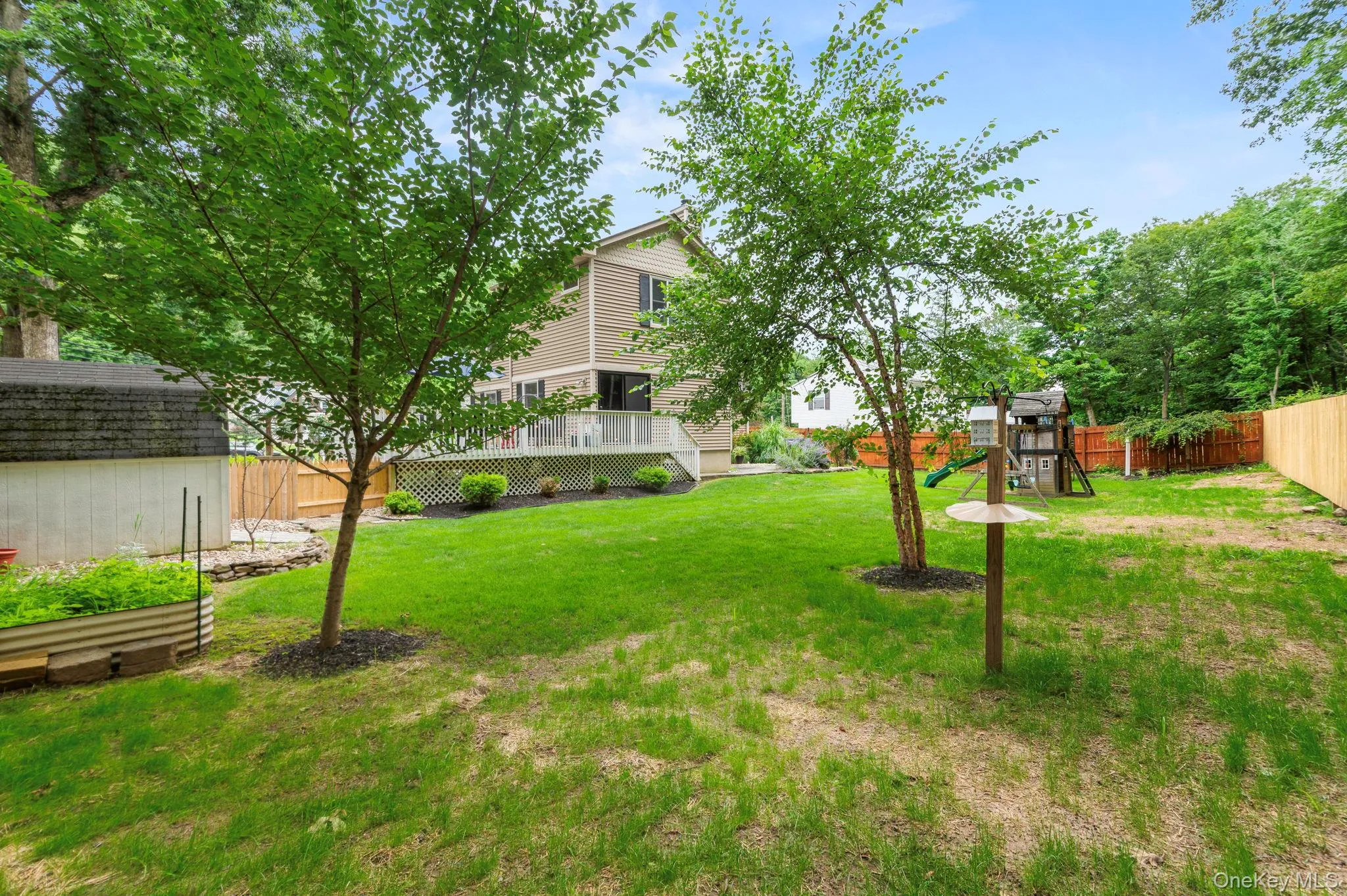 Expansive backyard featuring a manicured lawn Expansive backyard featuring a manicured lawn