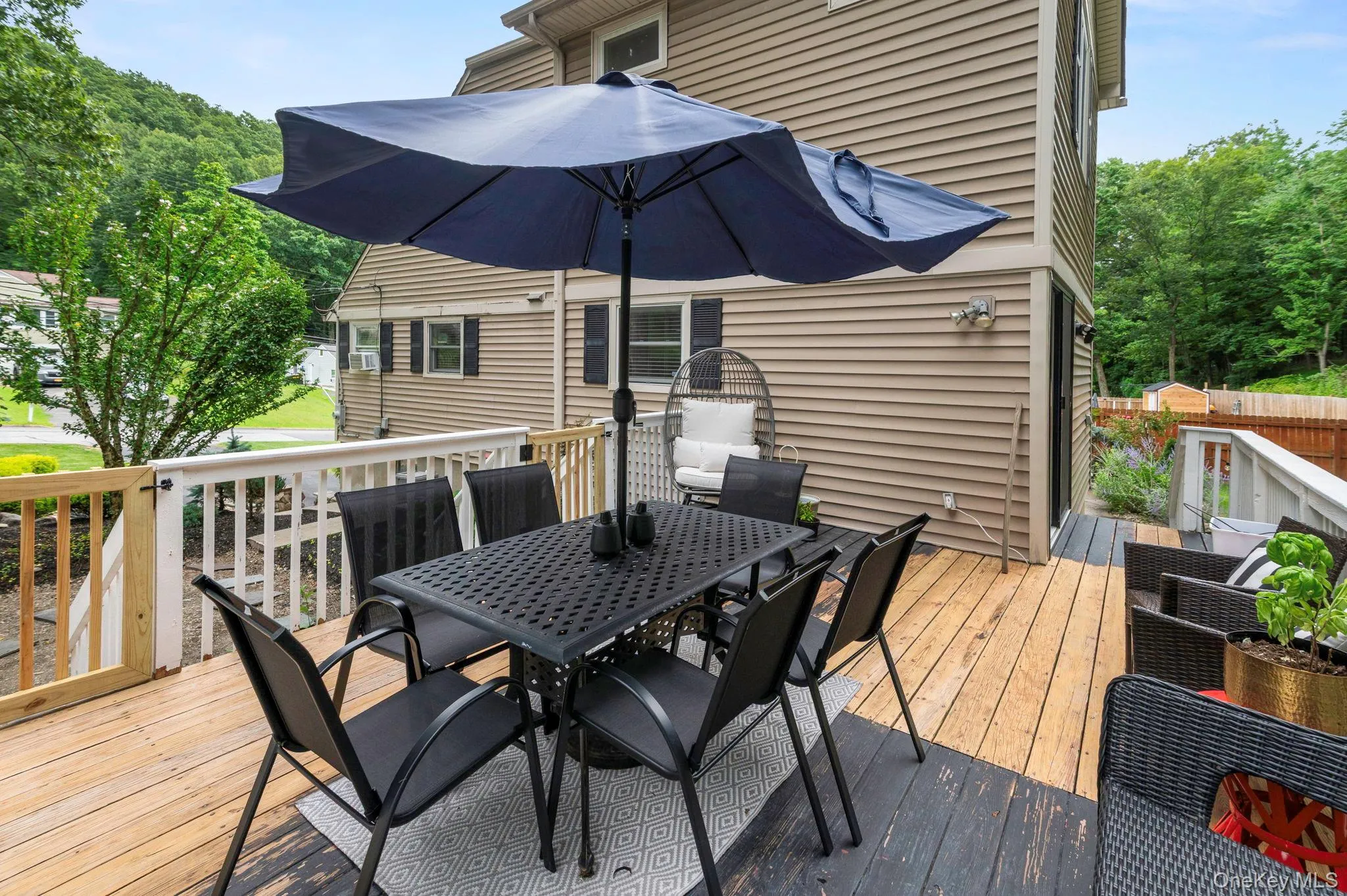 Expansive outdoor deck featuring wood flooring and white railings Expansive outdoor deck featuring wood flooring and white railings