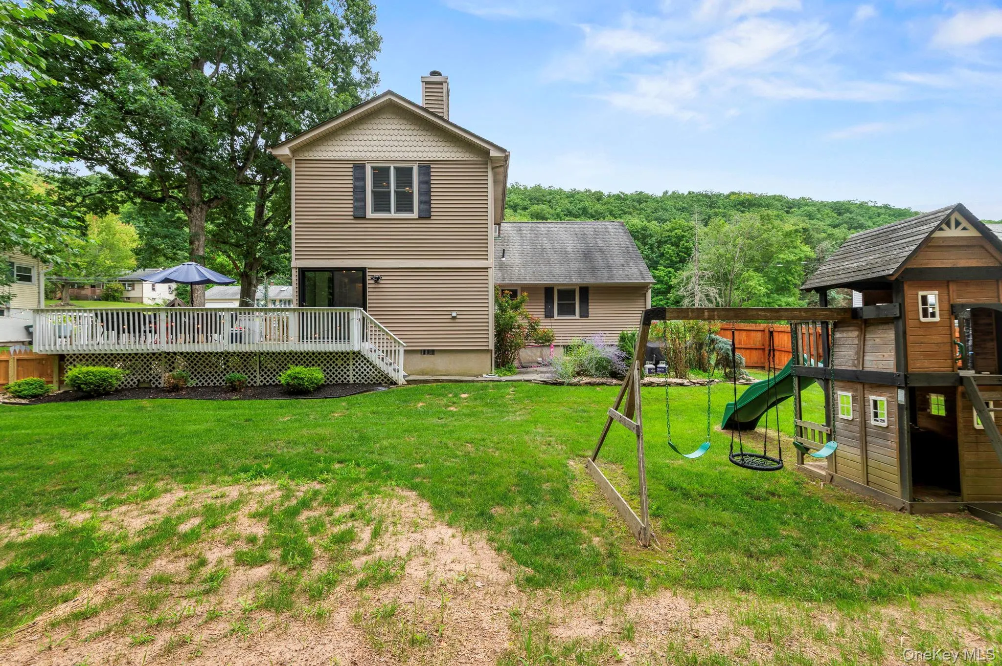 Expansive backyard with a manicured lawn Expansive backyard with a manicured lawn