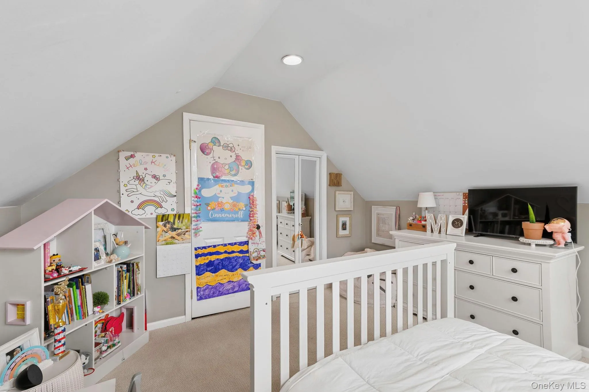 Angled ceiling featuring recessed lighting, a white painted door, and light-colored carpeting Angled ceiling featuring recessed lighting, a white painted door, and light-colored carpeting