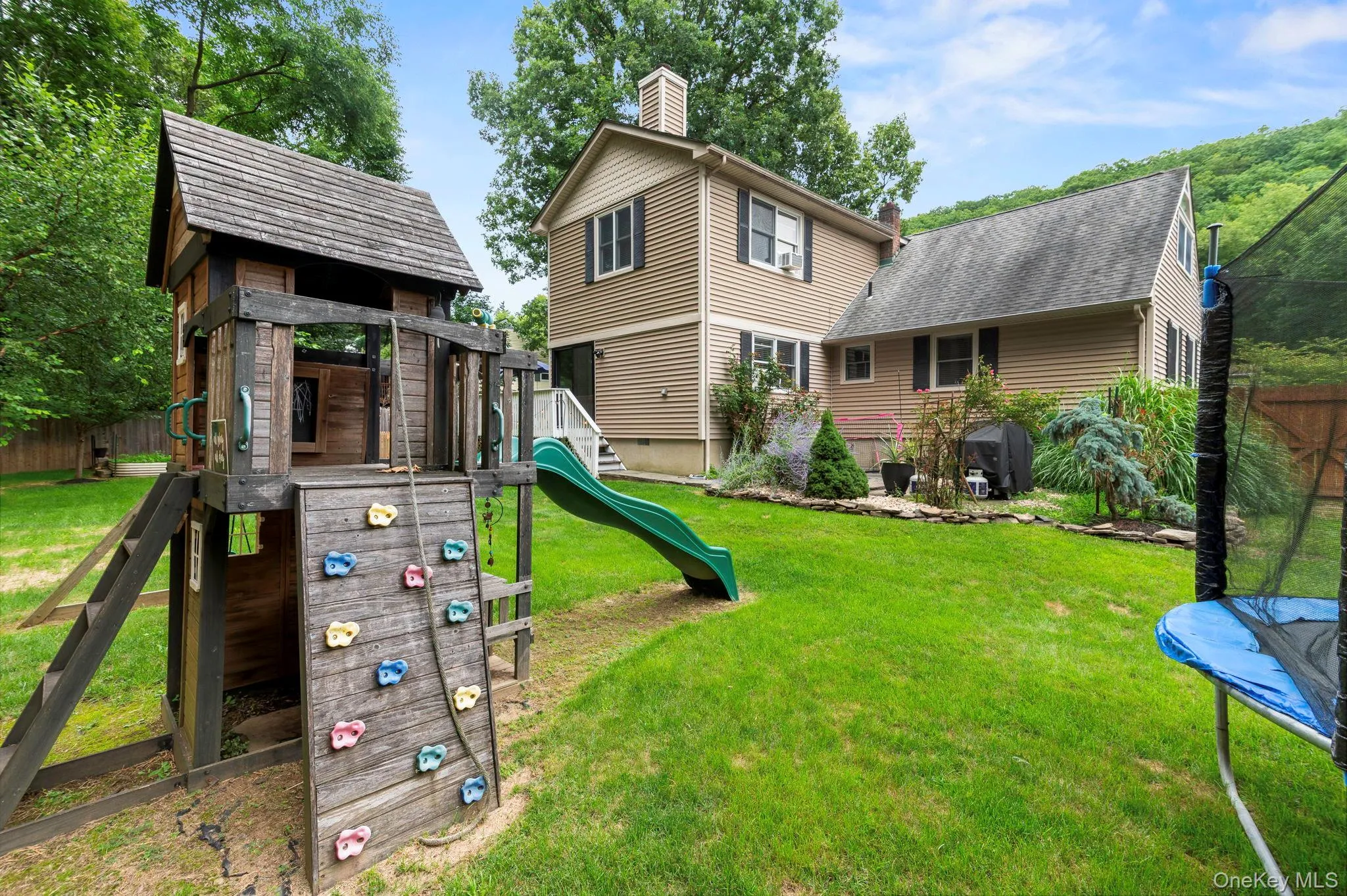 Expansive grassy lawn with established landscaping Expansive grassy lawn with established landscaping