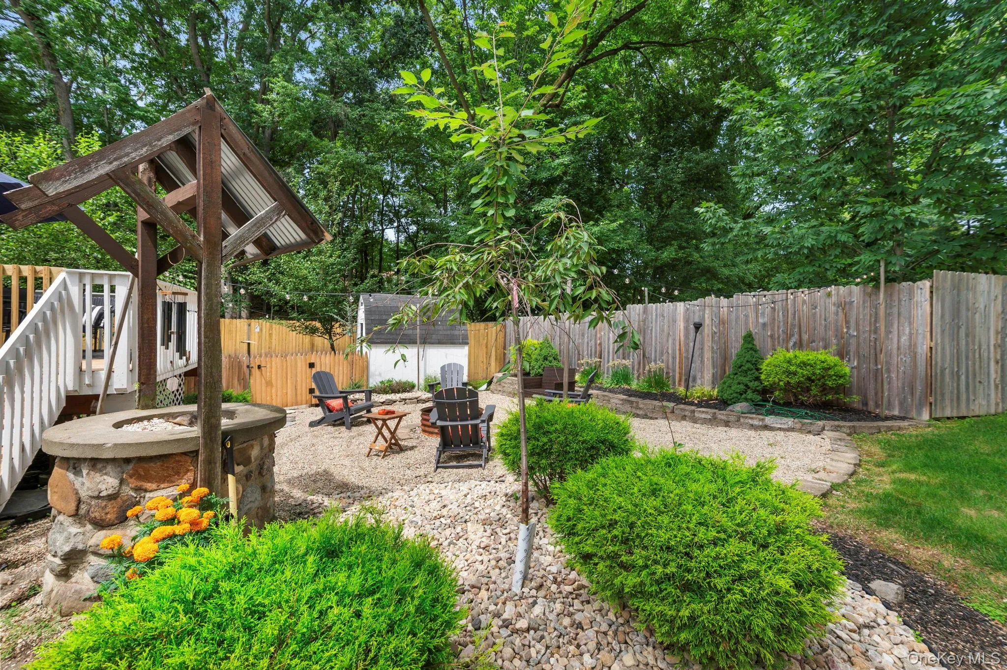 Expansive backyard featuring a gravel patio Expansive backyard featuring a gravel patio