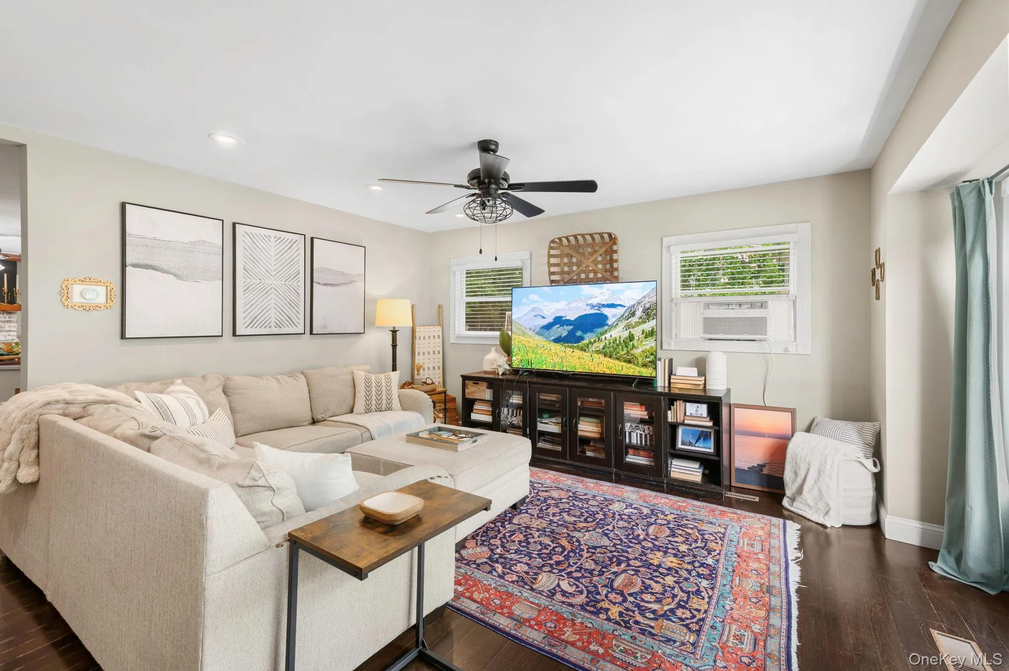 Dark wood-finish flooring, recessed lighting, and a ceiling fan with light fixture Dark wood-finish flooring, recessed lighting, and a ceiling fan with light fixture