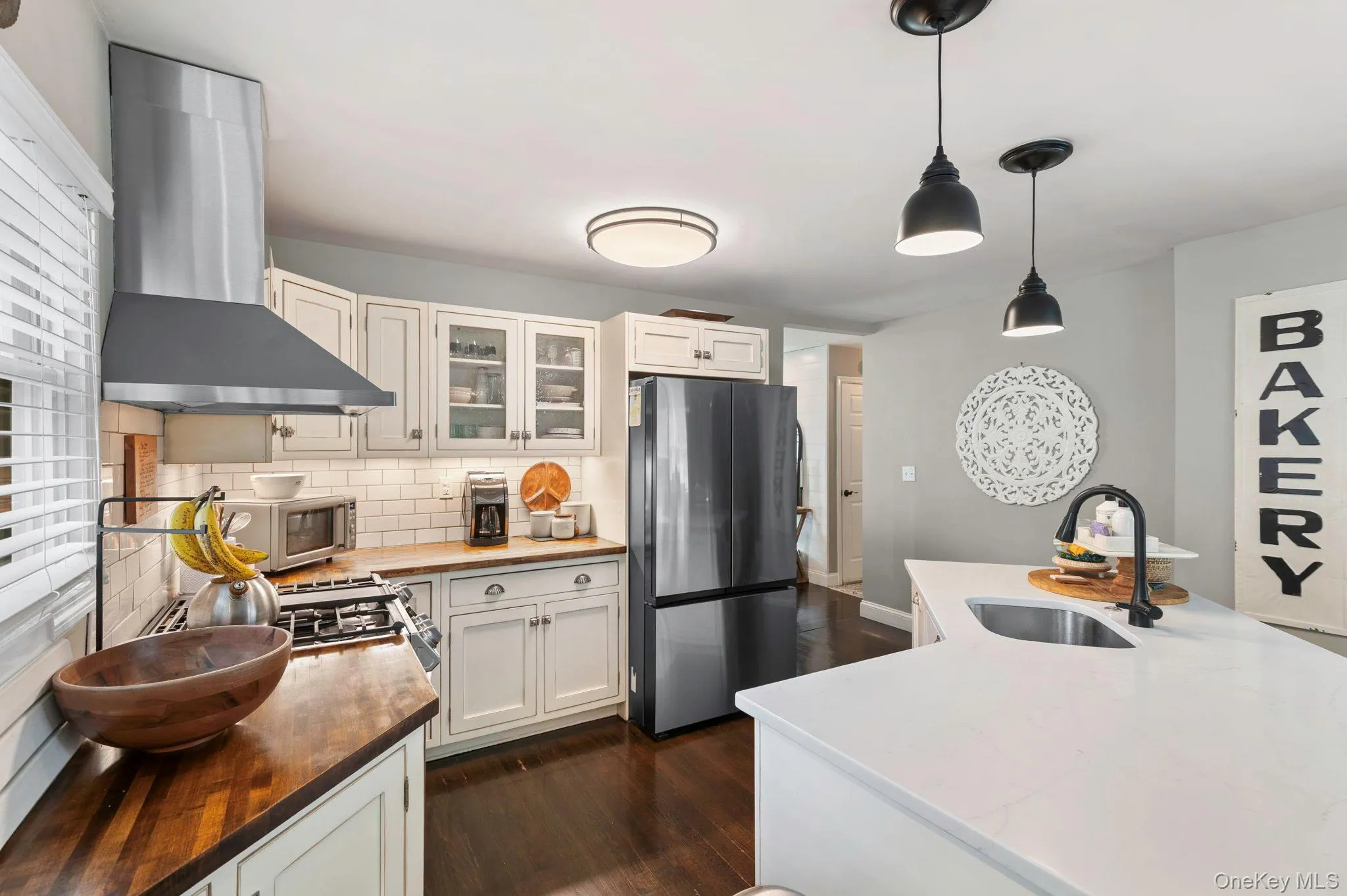 White shaker cabinetry with glass-front accents White shaker cabinetry with glass-front accents