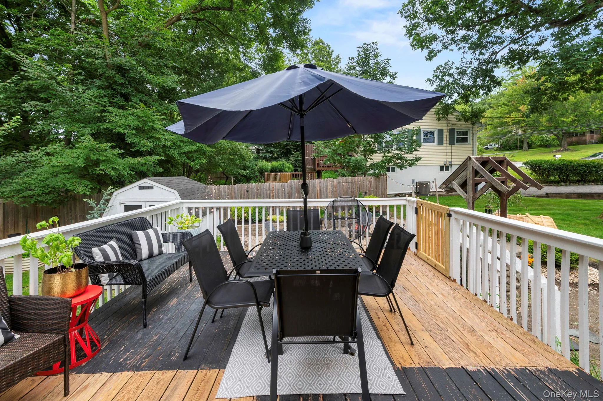 Spacious outdoor deck with wood flooring and white railing Spacious outdoor deck with wood flooring and white railing