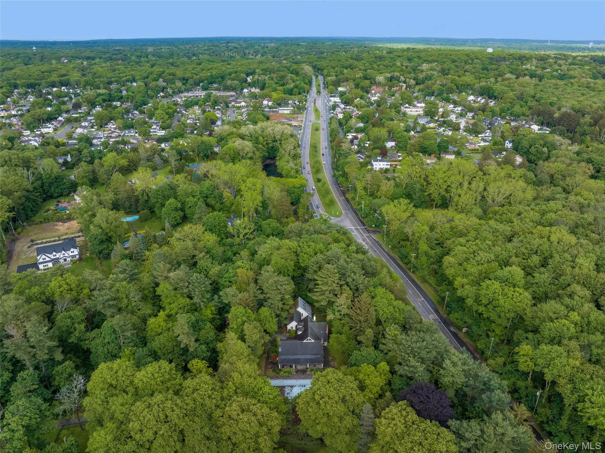 Aerial overview of property's location featuring a heavily wooded area Aerial overview of property's location featuring a heavily wooded area