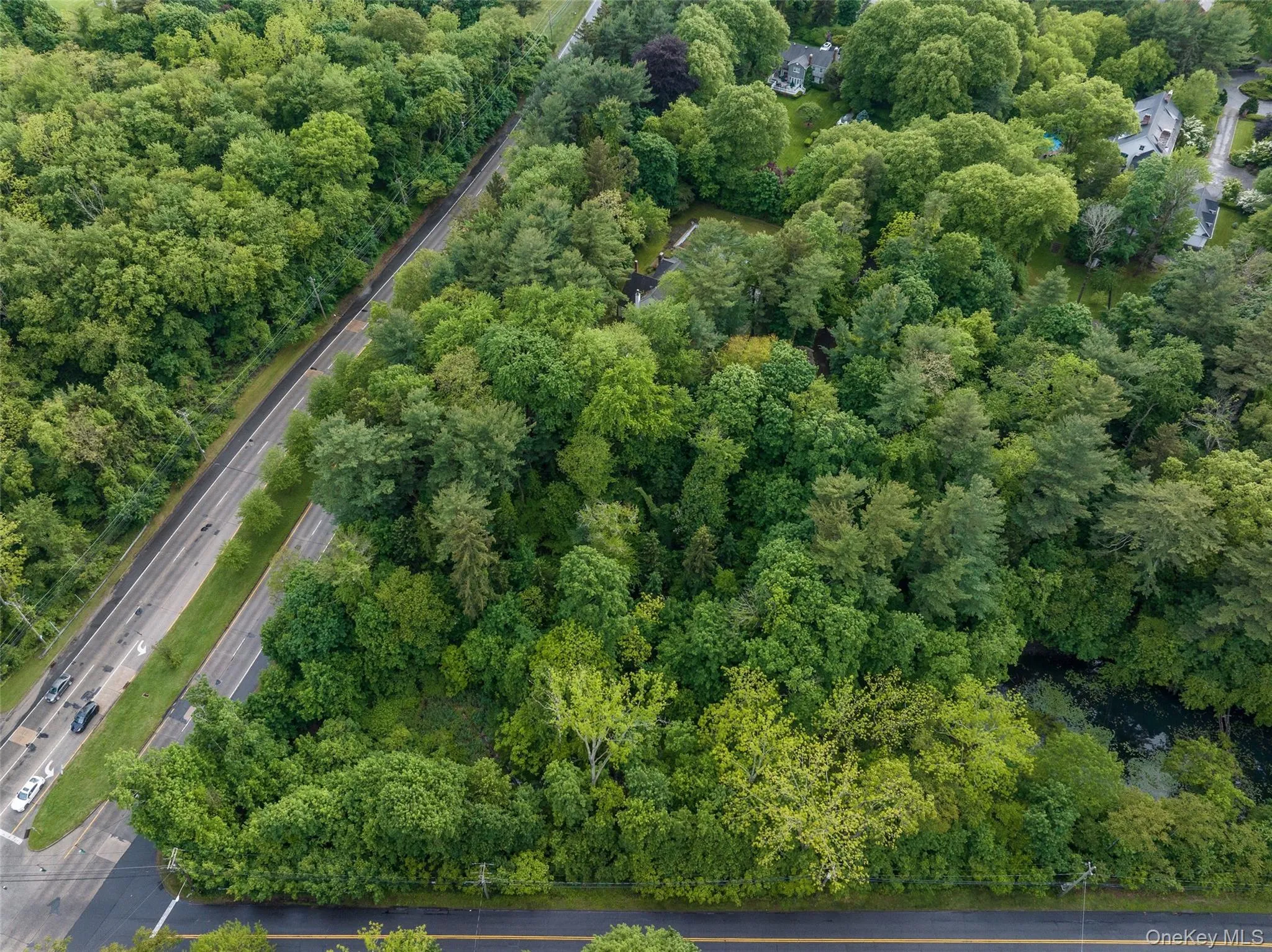 Aerial overview of property's location with a forest Aerial overview of property's location with a forest